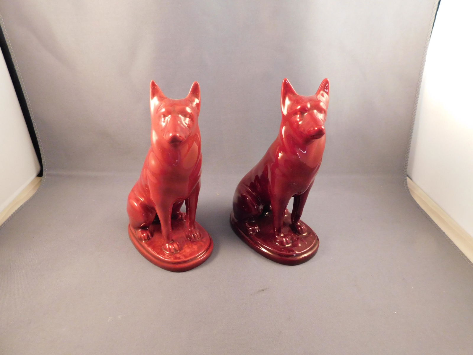 Pair of Zsolnay Dogs: Pair of Zsolnay red dogs. Measures approx. 5" tall x 3 1/4" wide. You are bidding at a live sale. Please read the terms and conditions. We are offering no contact pick up at our South Brunswick locati