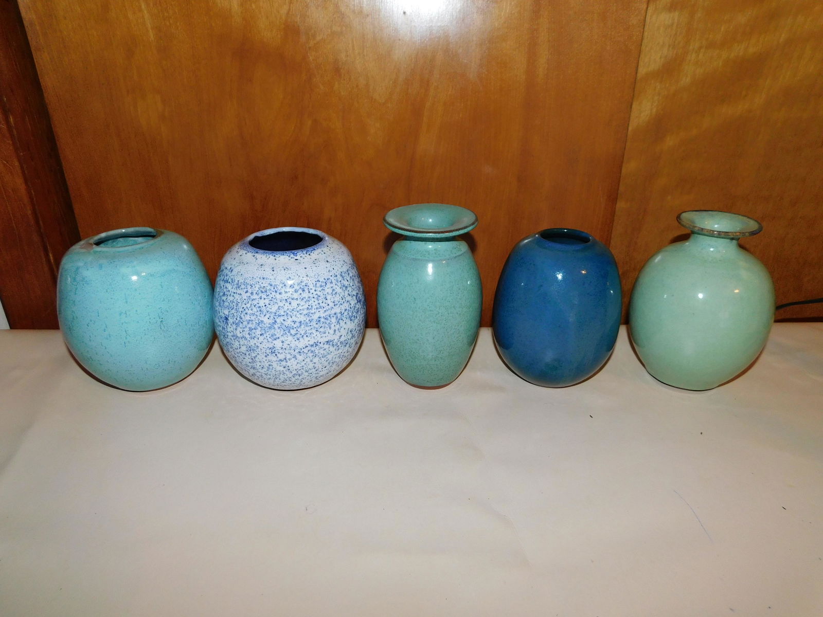 Lot of 5 Art Pottery Vases: Lot of 5 art pottery vases all marked New Clair Vaux. Measures approx. 4 1/2" - 5 1/2" tall. You are bidding at a live sale. Please read the terms and conditions. We are offering no contact pick up at