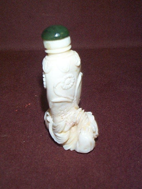 Asian white jade snuff bottle Hand carved with fl: Asian white jade snuff bottle Hand carved with flower and fish design Measures 2.5" tall Buyer to pay $15.00 all items to be sent UPS and packed by the UPS Store. Insurance is at an additional cost to