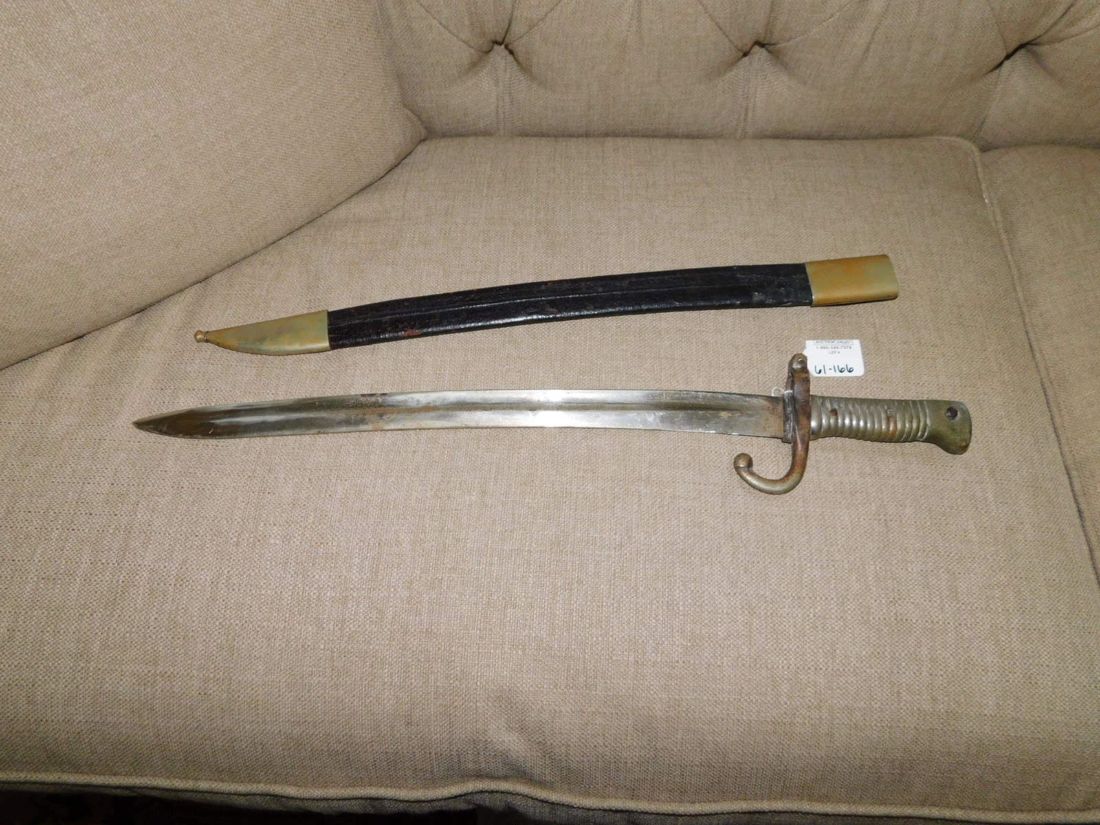 Chassepot Bayonet: Chassepot bayonet. Is marked but due to deterioration the markings are illegible. Has pitting and loss to the color. Has a leather scabbard. Measures approx. 22 1/2". You are bidding at a live sale, p