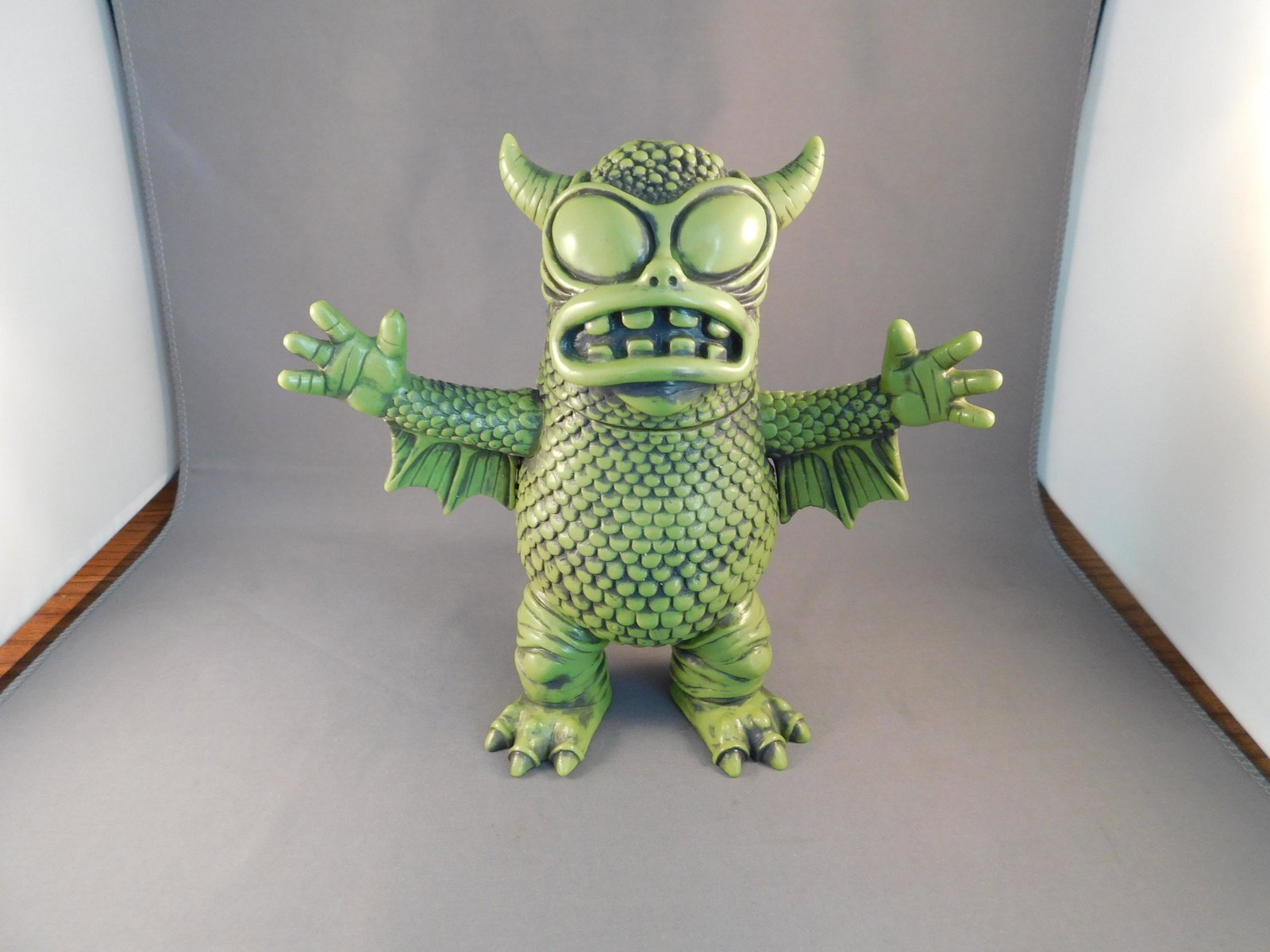 Japanese Vinyl Greasebat, Green: Japanese Vinyl real fighting Greasebat, Green. Signed Jeff Lamm, 2010. Measures approx. 6 1/2" tall. You are bidding at a live sale, please read the terms and conditions. We are offering contact-less 