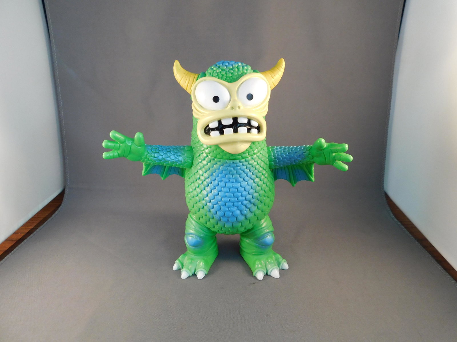 Japanese Vinyl Greasebat, Green Multicolored: Japanese Vinyl real fighting Greasebat, green multicolored. Signed Jeff Lamm, 2010. Measures approx. 6 1/2" tall. You are bidding at a live sale, please read the terms and conditions. We are offering 