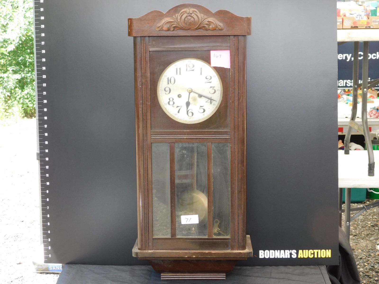 Mahogany Wall Clock: Magohany Wall Regulator Clock. Measures 30" tall 13" wide. You are bidding at a live sale. Please read the terms and conditions. This sale will be broadcast live on sale day with full descriptions of