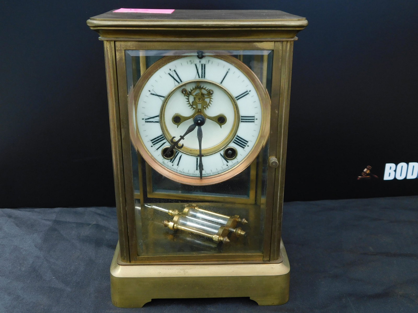 Crystal Regulator Clock: Crystal Regulator Clock with Mercury Penndulum and an open escapement. Signed Asonia Clock Measures 9.5" x 6.5". You are bidding at a live sale. Please read the terms and conditions. This sale will be