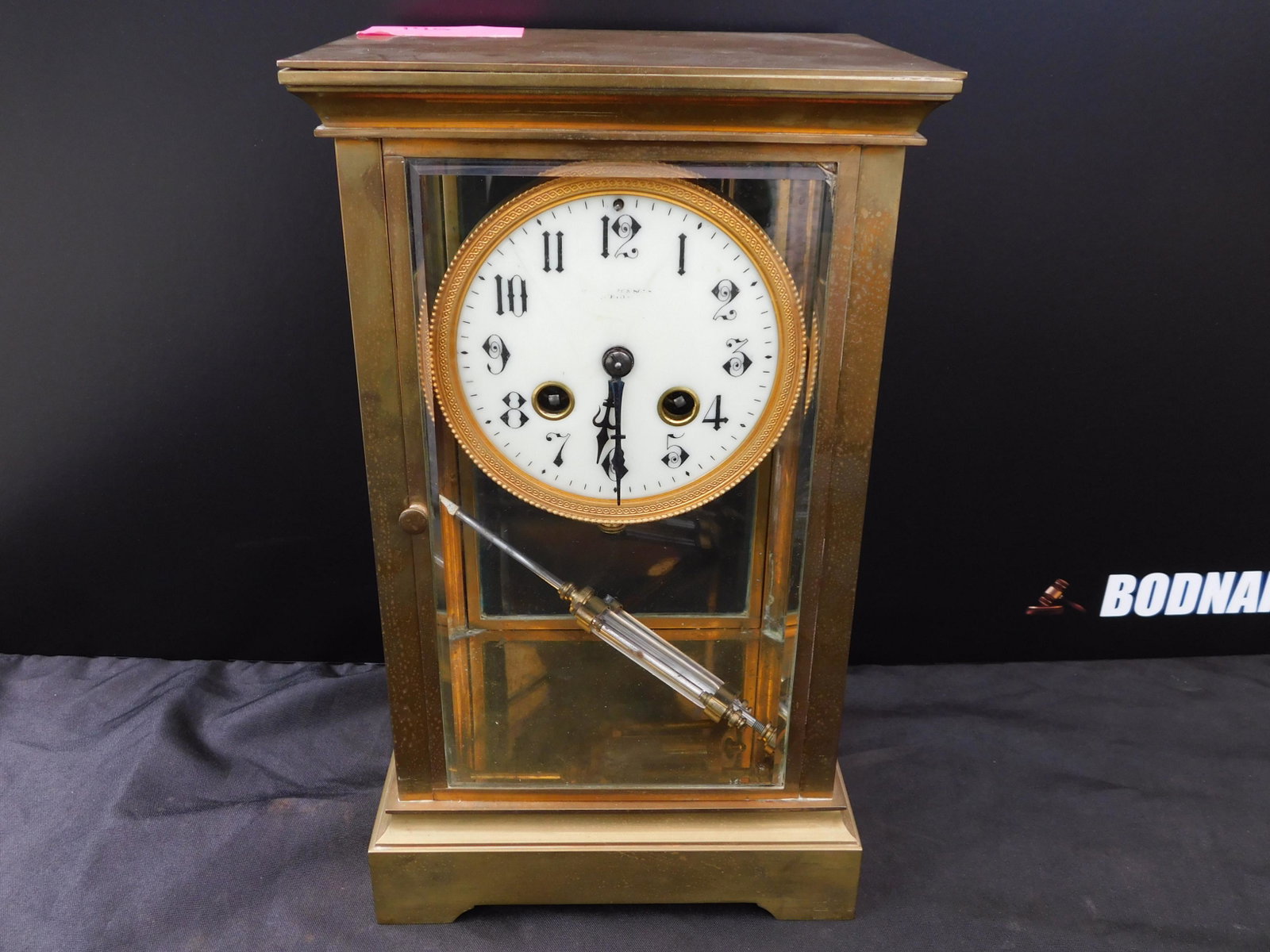 Crystal Regulator Clock: Crystal Regulator Clock with Mercury Glass Pendullum. Measures 11" x 7" wide. You are bidding at a live sale. Please read the terms and conditions. This sale will be broadcast live on sale day with fu