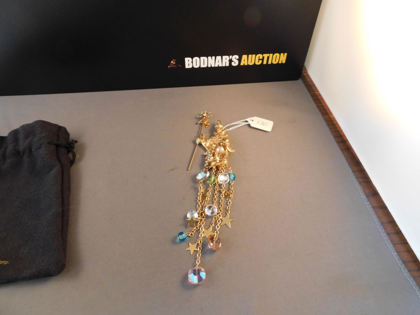 Kirks Folly Wizard Pin: Kirks Folly gold tone wizard pin with charms & crystals. Marked on the back. Measures 6 3/4" long. You are bidding at a live sale. Please read the terms and conditions. We are offering no contact pick