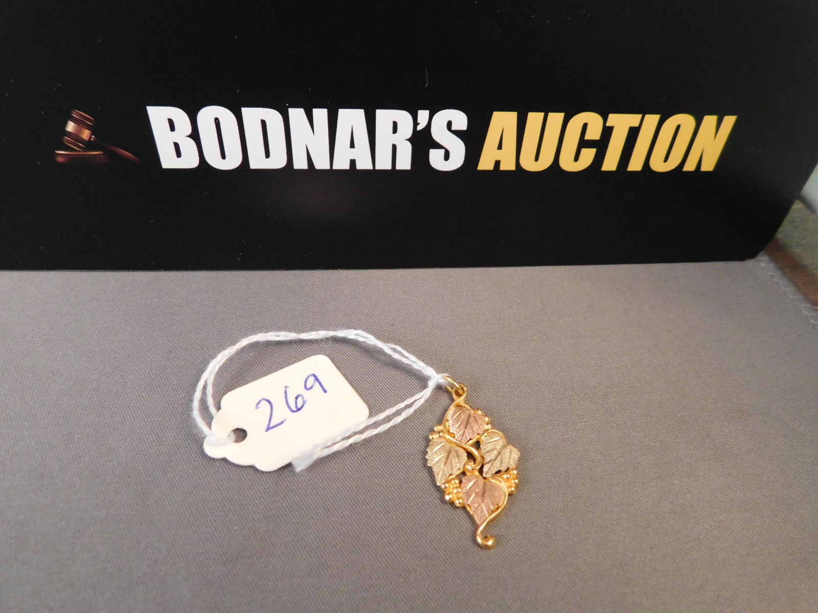 Black Hills Gold 10K Leaf Pendant: Black Hills Gold 10K tri-color leaf pendant. Marked on back. Measures 1". You are bidding at a live sale. Please read the terms and conditions. We are offering no contact pick up at our South Brunswic