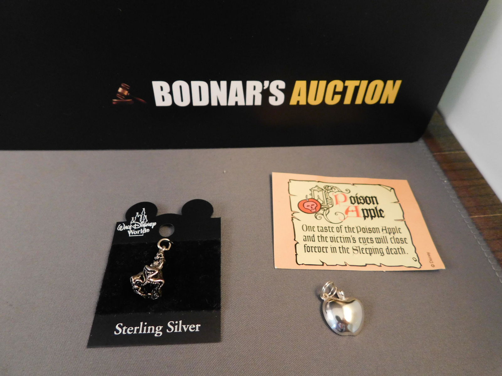 2 Sterling Snow White Charms: 2 Sterling Snow White and the Seven Dwarfs charms including Snow White on black Walt Disney World Card. Is also marked on the back Disney 925. Measures approx. 1" long and a Walt Disney Classics Colle