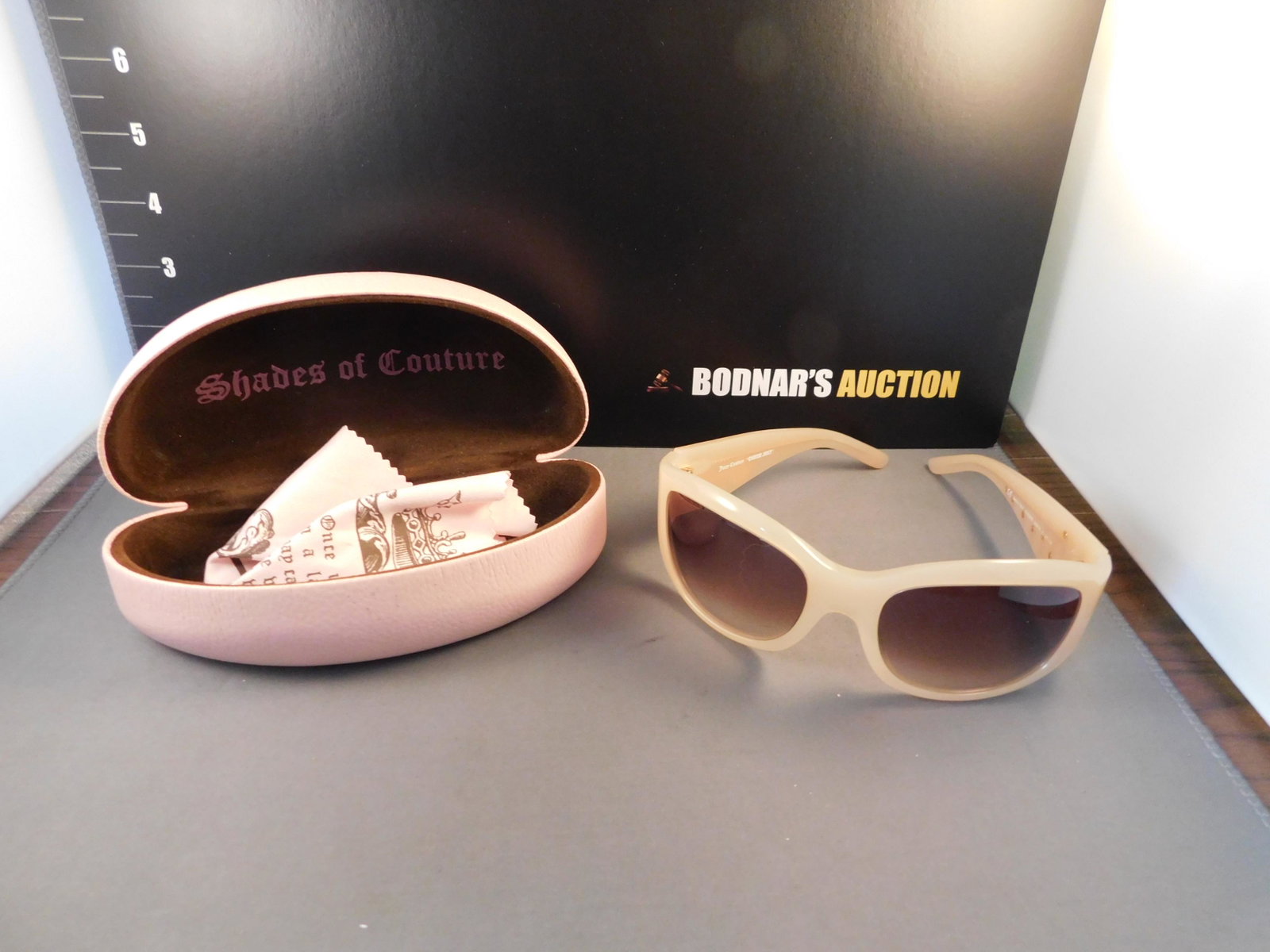 Juicy Couture Sunglasses: Juicy Couture sunglasses in a pink case with cleaning cloth. You are bidding at a live sale. Please read the terms and conditions. We are offering no contact pick up at our South Brunswick location. P