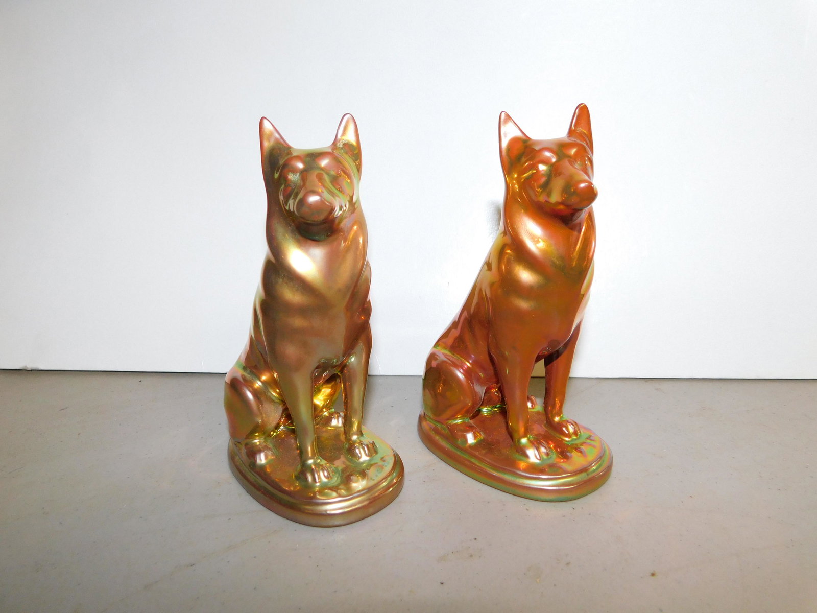 Pair of Zsolnay Eosin Art Pottery German Shepard: Pair of Zsolnay Eosin Art Pottery German Shepard Figurines. Measures 5" tall. You are bidding at a live sale. Please read the terms and conditions. We are offering no contact pick up at our South Brun