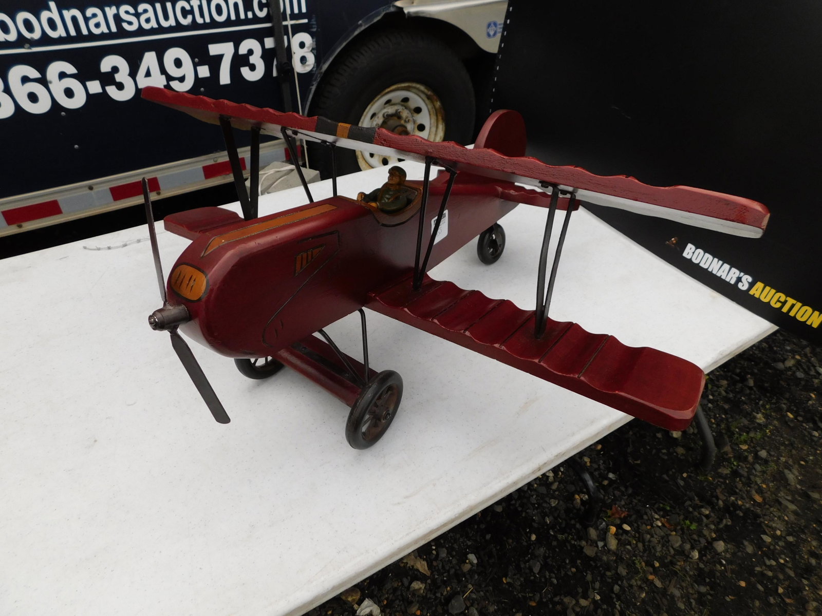 carved wood bi-plane: carved wood bi-plane measures 26 inches long by 14 inches tall You are bidding at a live sale. You are bidding at a live sale. Please read the terms and conditions. This sale will be broadcast live on