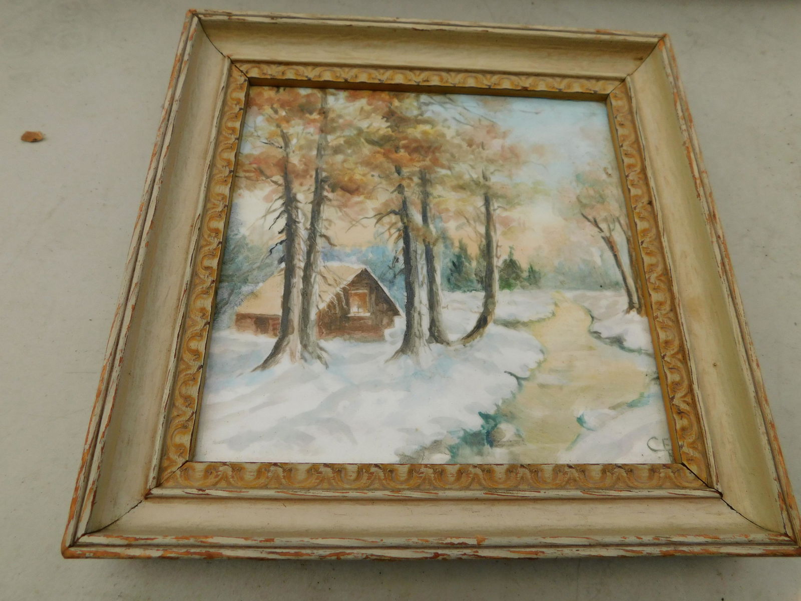 Hand Painted Tile of Cottage: Framed Hand Painted Tile Artist Sign depicting Winter Cottage Scene. Measures 6" x 6" You are bidding at a live sale. Please read the terms and conditions. We are offering no contact pick up at our So