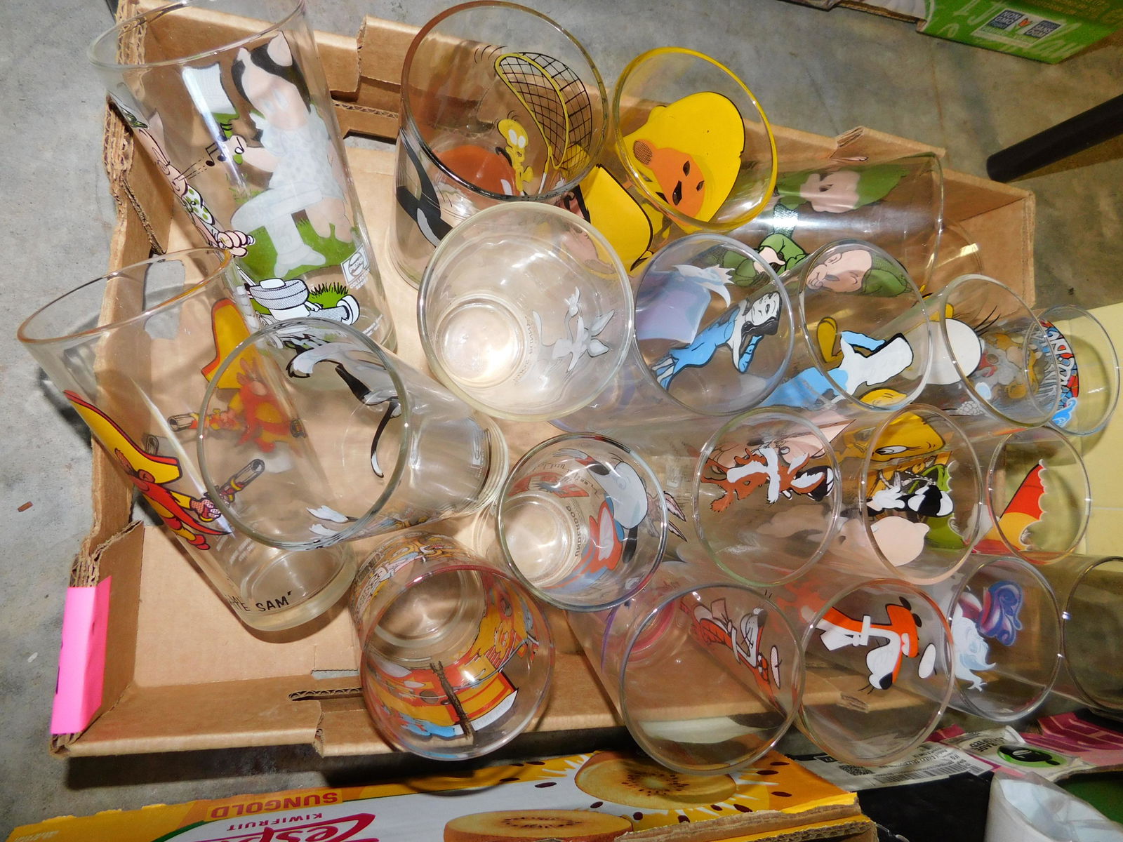 Box Lot of Cartoon Related Drinking Glasses: Box Lot with Cartoon Related Drinking Glasses. Approx 20 glasses. You are bidding at a live sale. Please read the terms and conditions. This sale will be broadcast live on sale day with full descripti