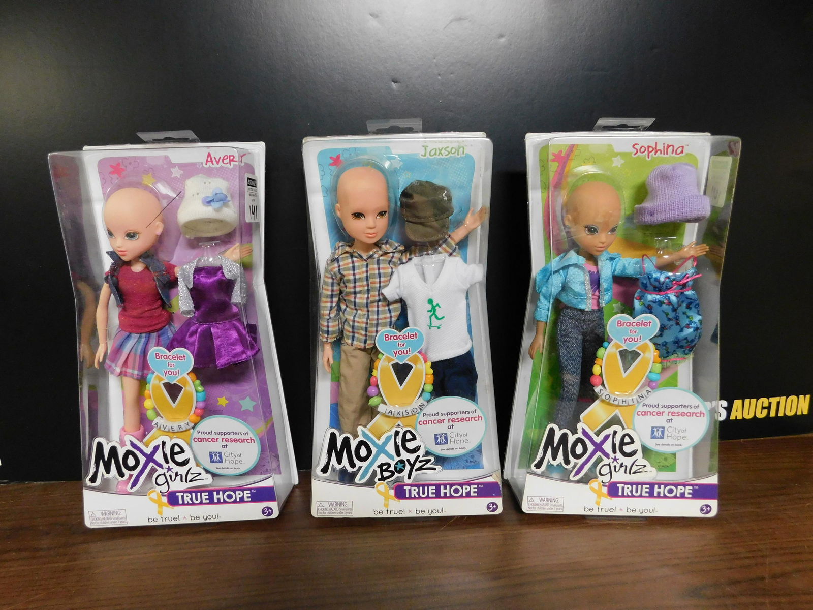 Lot of 3 Moxie True Hope Dolls: Lot of 3 Moxie True Hope Doll Lot. Included in this lot are Jaxson, Sophina, and Avery. All made to support cancer research at City of Hope. Made by MGA Entertainment. You are bidding at a live sale.