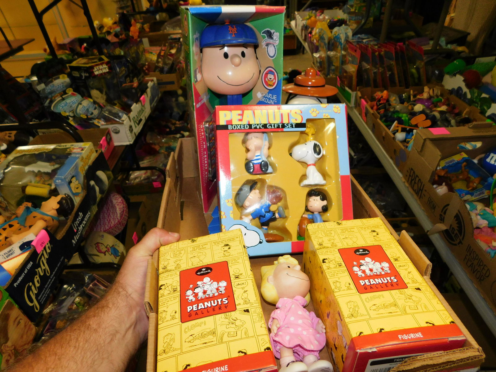 Lot of Peanuts: Box Lot of Peanuts figures and Giant Pez. You are bidding at a live sale. Please read the terms and conditions. This sale will be broadcast live on sale day with full descriptions of each lot being so
