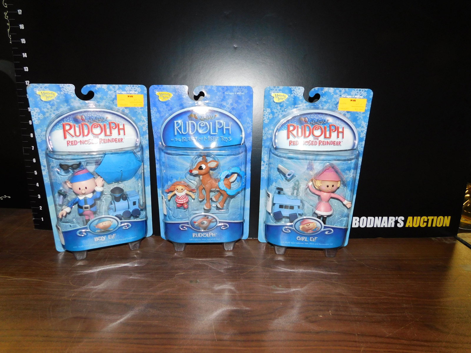 3 Rudolph Figures: Lot of three figures. 2 are from Rudolph the Red Nosed Reindeer and include Boy Elf and Girl Elf and the last is from The Island of the Misfit Toys and is a Rudolph figure. All three are in original p