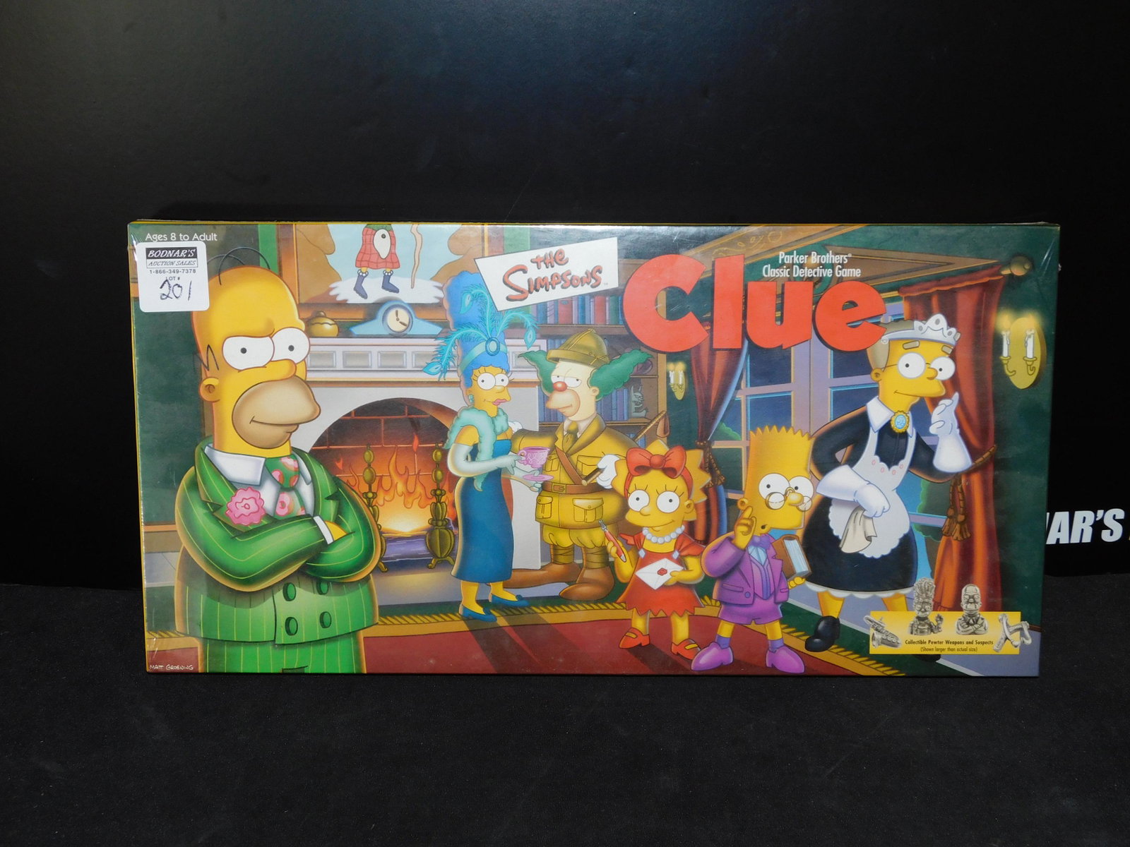 The Simpsons Clue: The Simpsons Clue, factory sealed in original box, by Parker Brothers. You are bidding at a live sale, please read the terms and conditions. We are offering contact-less pick ups at our South Brunswic