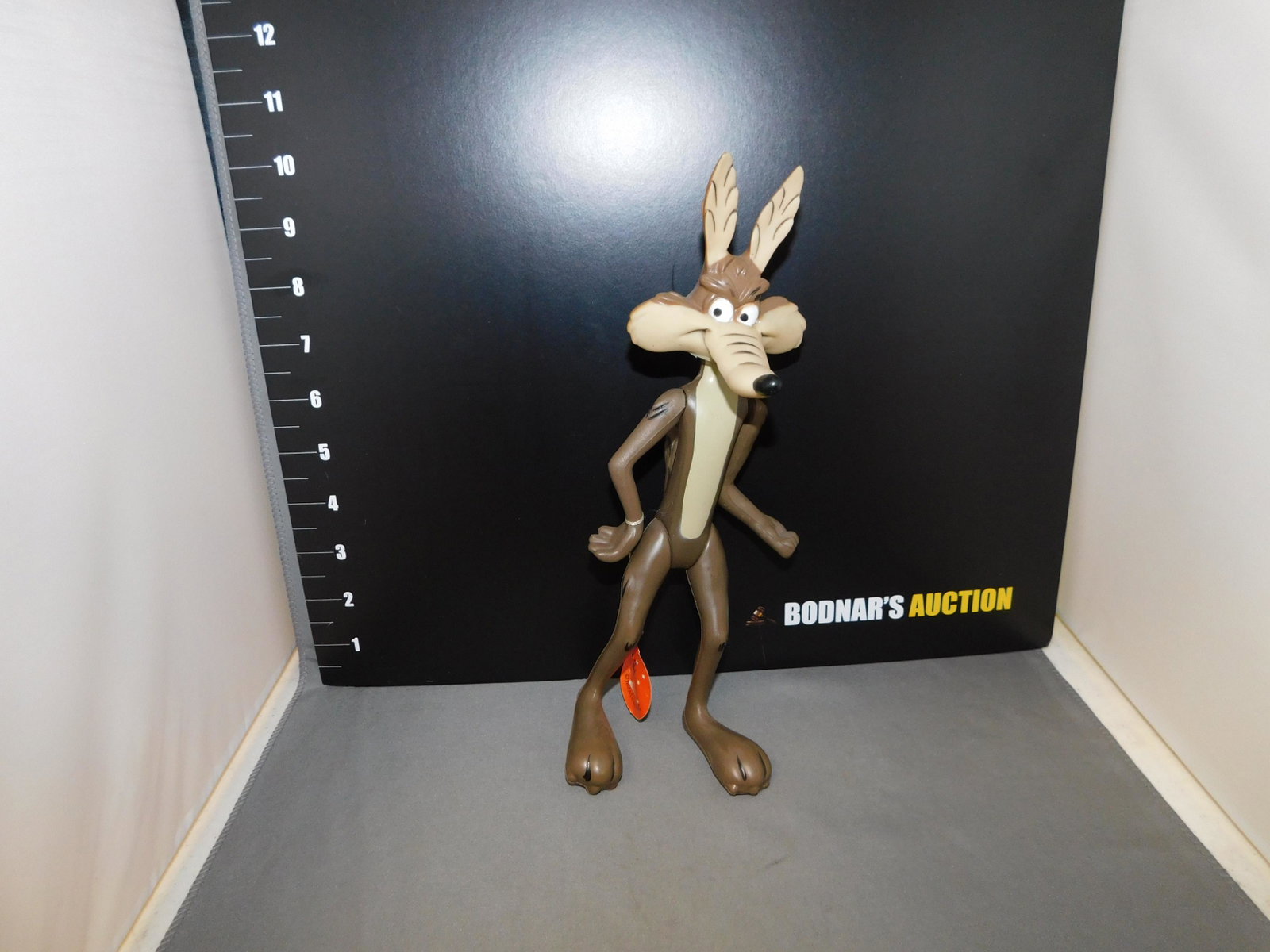 R. Dakin Wile E Cyote Figure: R. Dakin Wile E Cyote figure marked 1968. Has original tag. Measures approx. 9 3/4" tall. You are bidding at a live sale, please read the terms and conditions. We are offering contact-less pick ups at