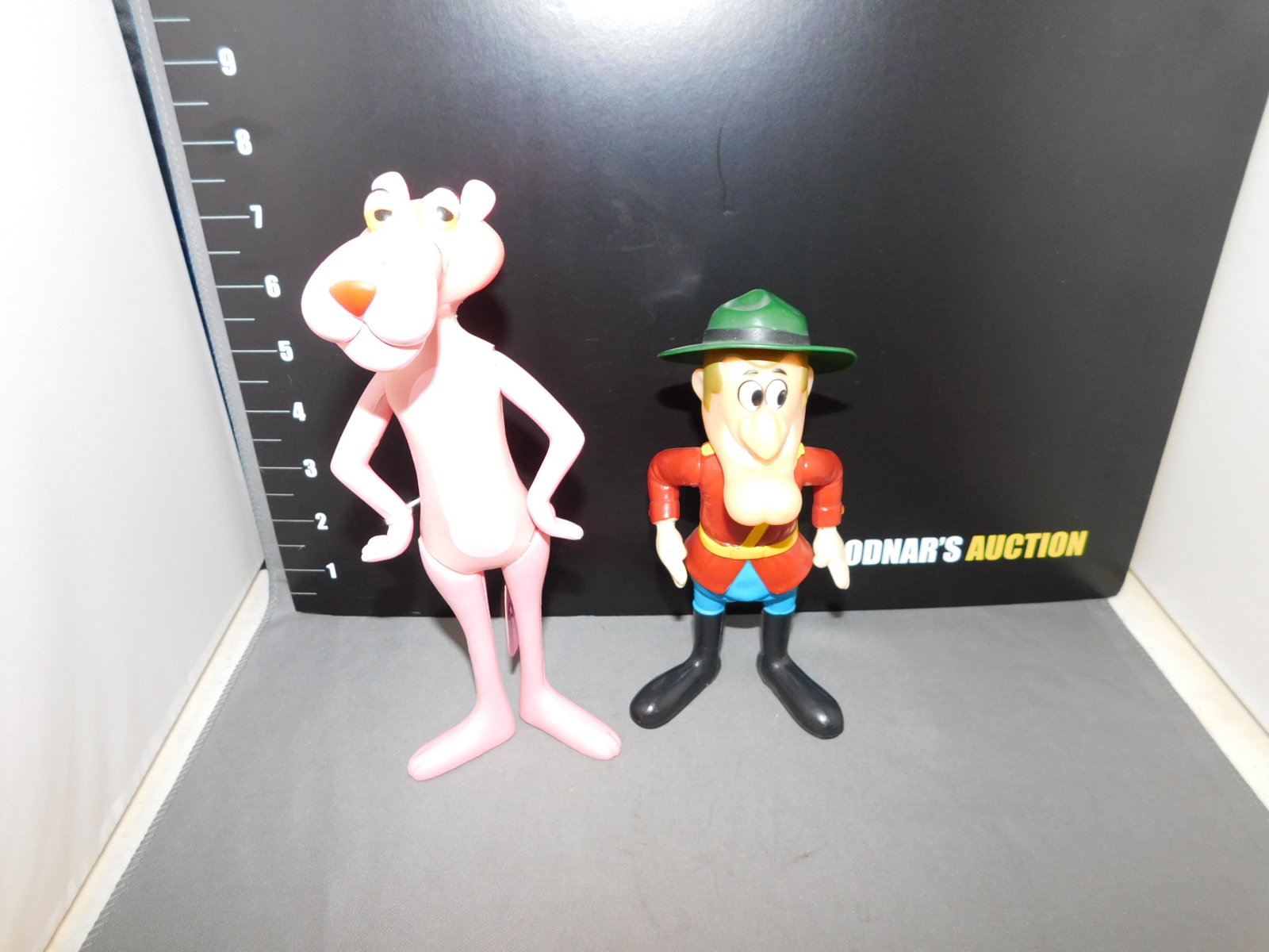 R. Dakin Pink Panther and Dudley Do Right: R. Dakin Pink Panther marked 1971 and with original tag, and Dudley Do Right marked 1976. Measures approx. 6 1/2" - 8" tall. You are bidding at a live sale, please read the terms and conditions. We ar