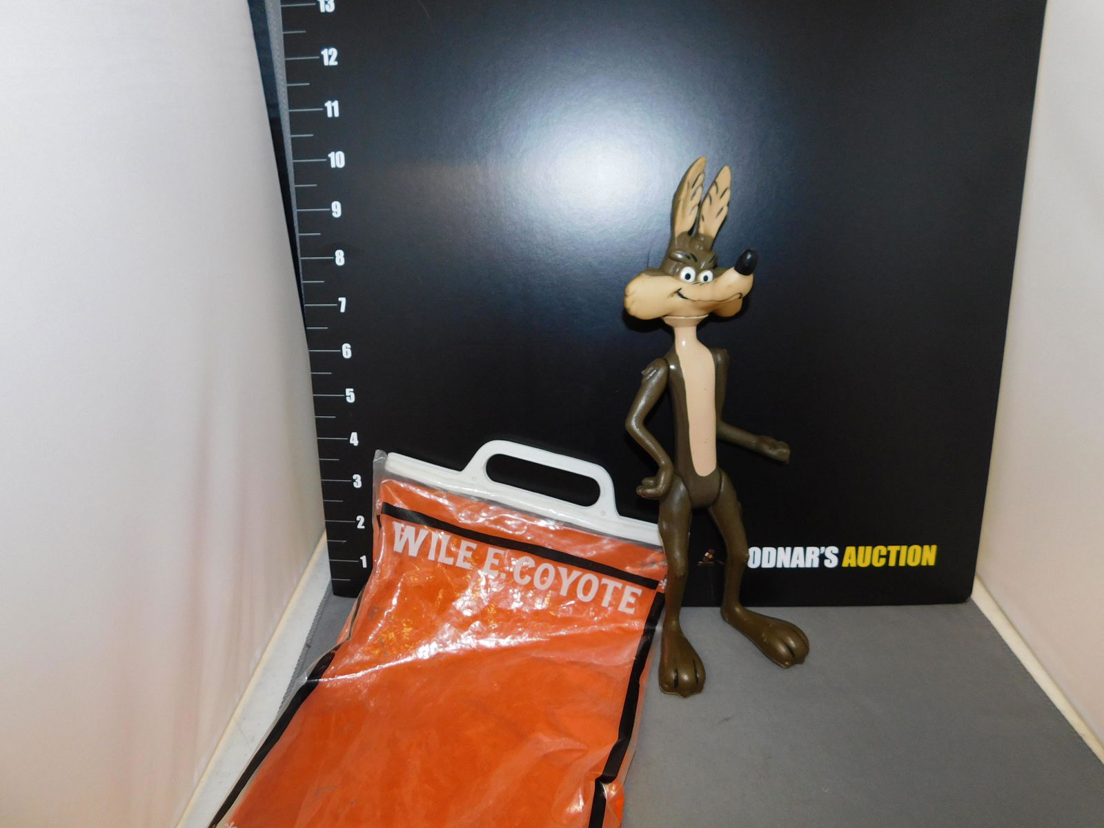 R. Dakin Wile E Cyote Figure: R. Dakin Wile E Coyote in original bag and marked 1968. Measures approx. 10 1/4" tall. You are bidding at a live sale, please read the terms and conditions. We are offering contact-less pick ups at ou