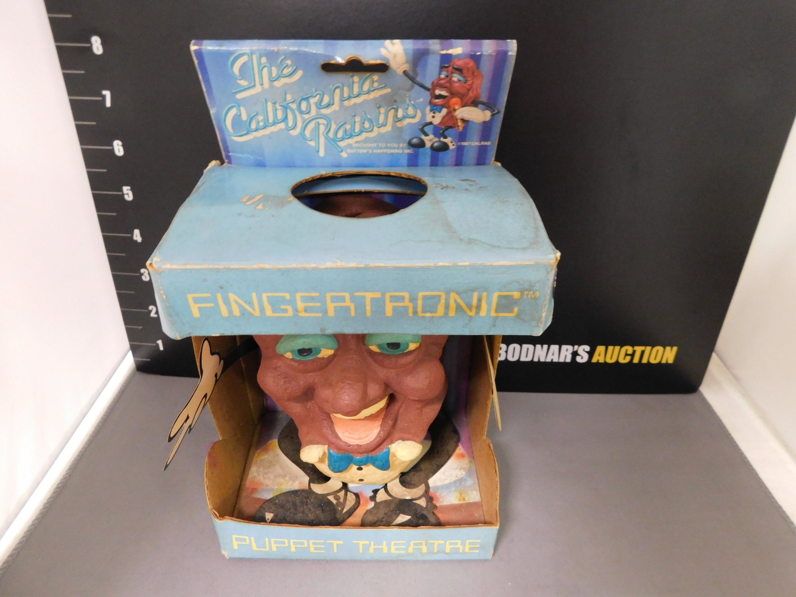California Raisins Fingertronic Puppet Theater: Fingertronic Puppet Theater. California Raisins 1987. Box and puppet have some wear. Comes in original Box