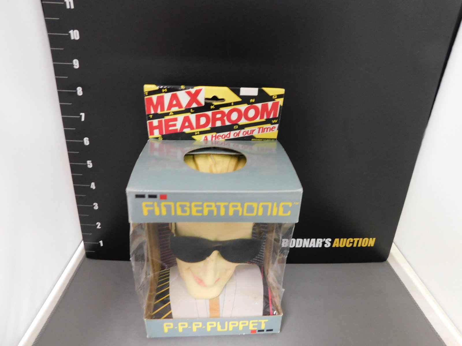 Max Headroom Fingertronic Puppet: Fingertronic P-P-P-Puppet Max Headroom. The puppet comes in the original box. Box has some wear. You are bidding at a live sale, please read the terms and conditions. We are offering contact-less pick