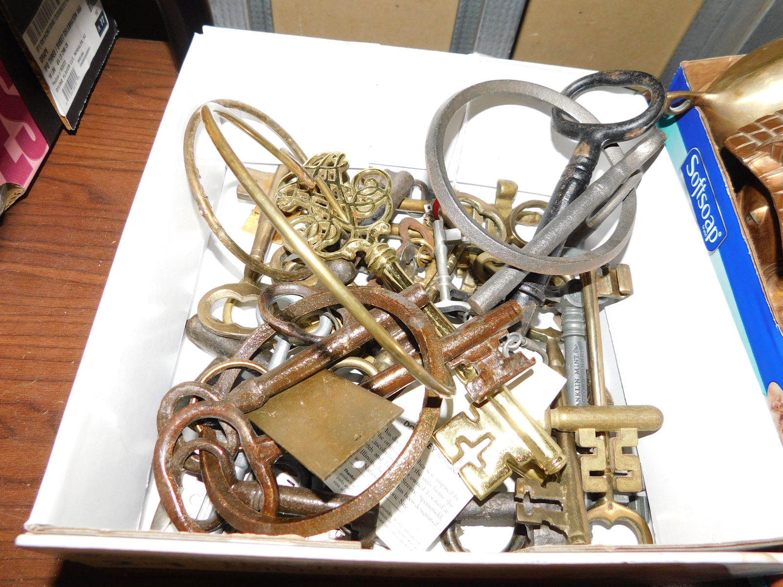 Box Lot of Brass and Metal Keys: Box Lot of Brass and Metal Keys. You are bidding at a live sale. Please read the terms and conditions. This sale will be broadcast live on sale day with full descriptions of each lot being sold, as we