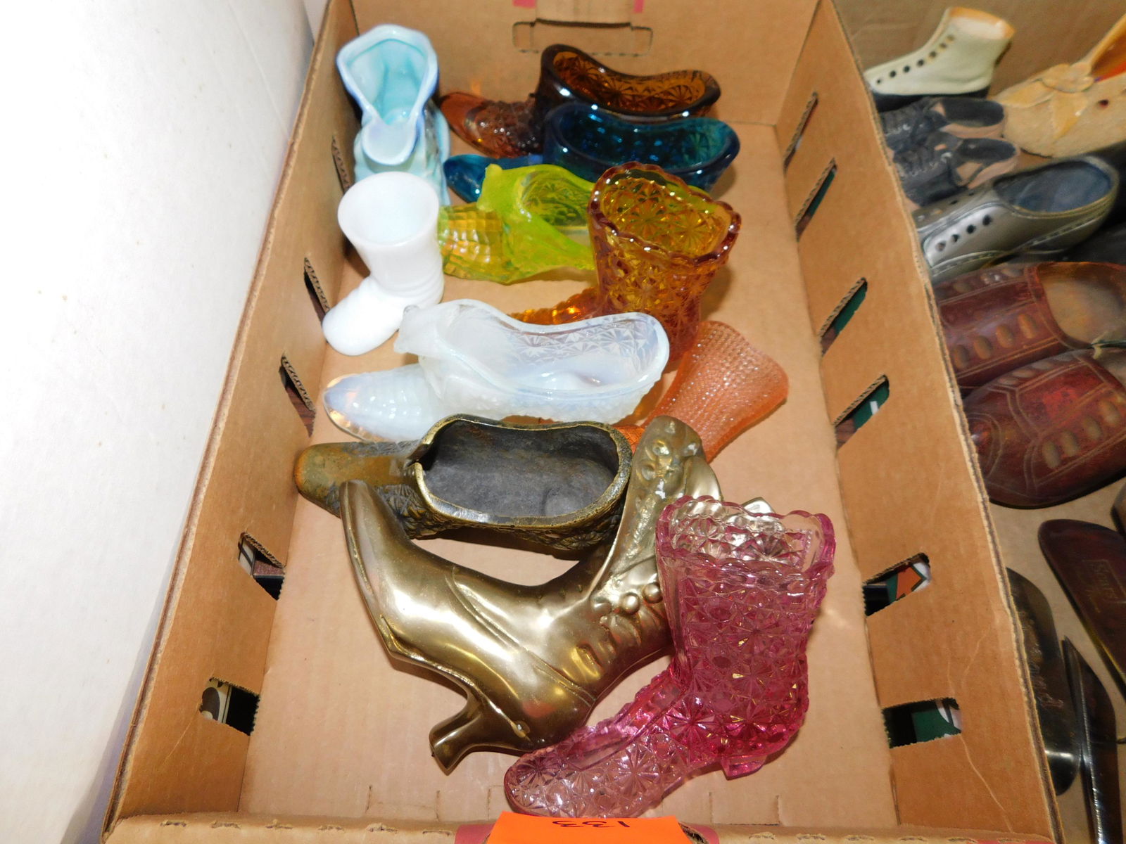 Box Lot of Glass Shoes: Box Lot of Glass Shoes. You are bidding at a live sale. Please read the terms and conditions. This sale will be broadcast live on sale day with full descriptions of each lot being sold, as well as vid