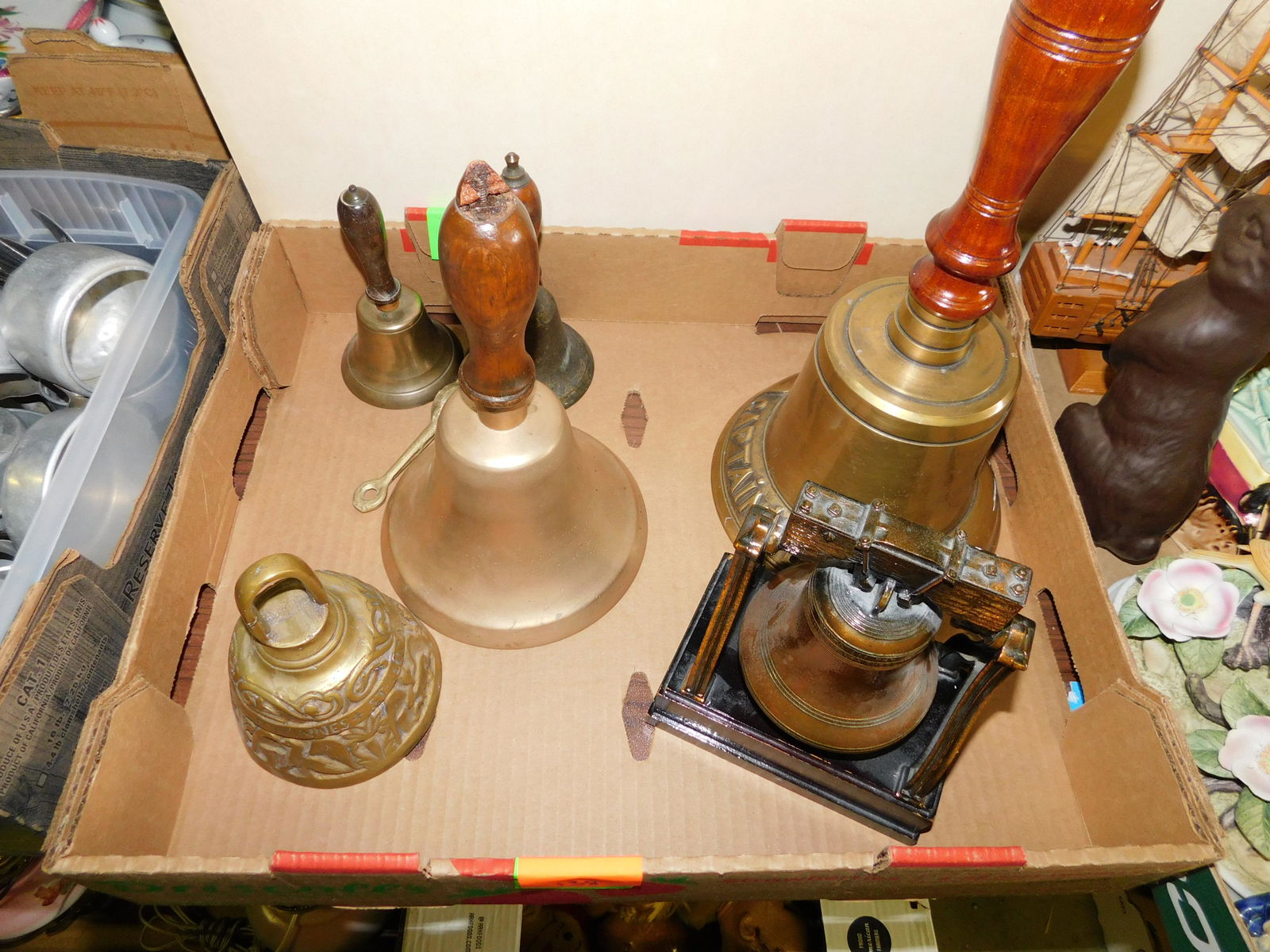 Box Lot of Brass Bells: Box Lot of Brass Bells. You are bidding at a live sale. Please read the terms and conditions. This sale will be broadcast live on sale day with full descriptions of each lot being sold, as well as vid