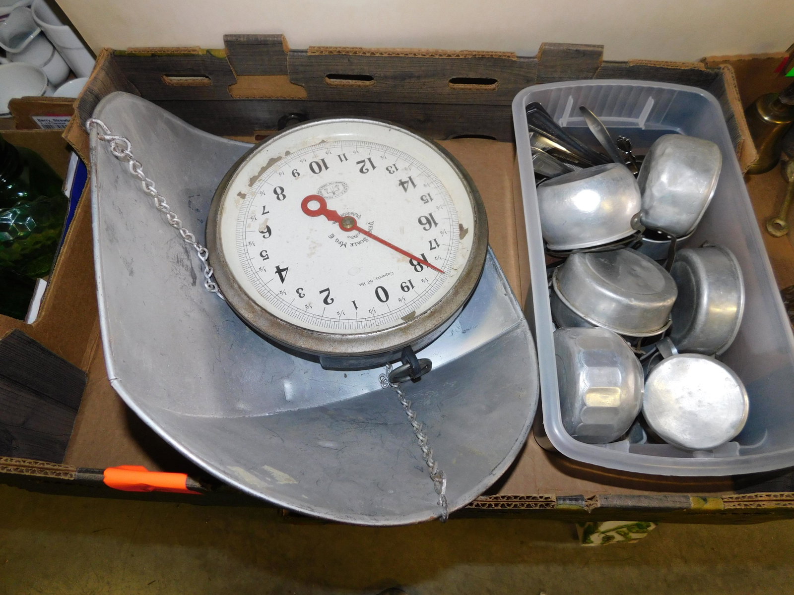 Box Lot with Scale and Kitchen Aluminum Ware: Box Lot with Scale and Aluminum Kitchenware. You are bidding at a live sale. Please read the terms and conditions. This sale will be broadcast live on sale day with full descriptions of each lot being