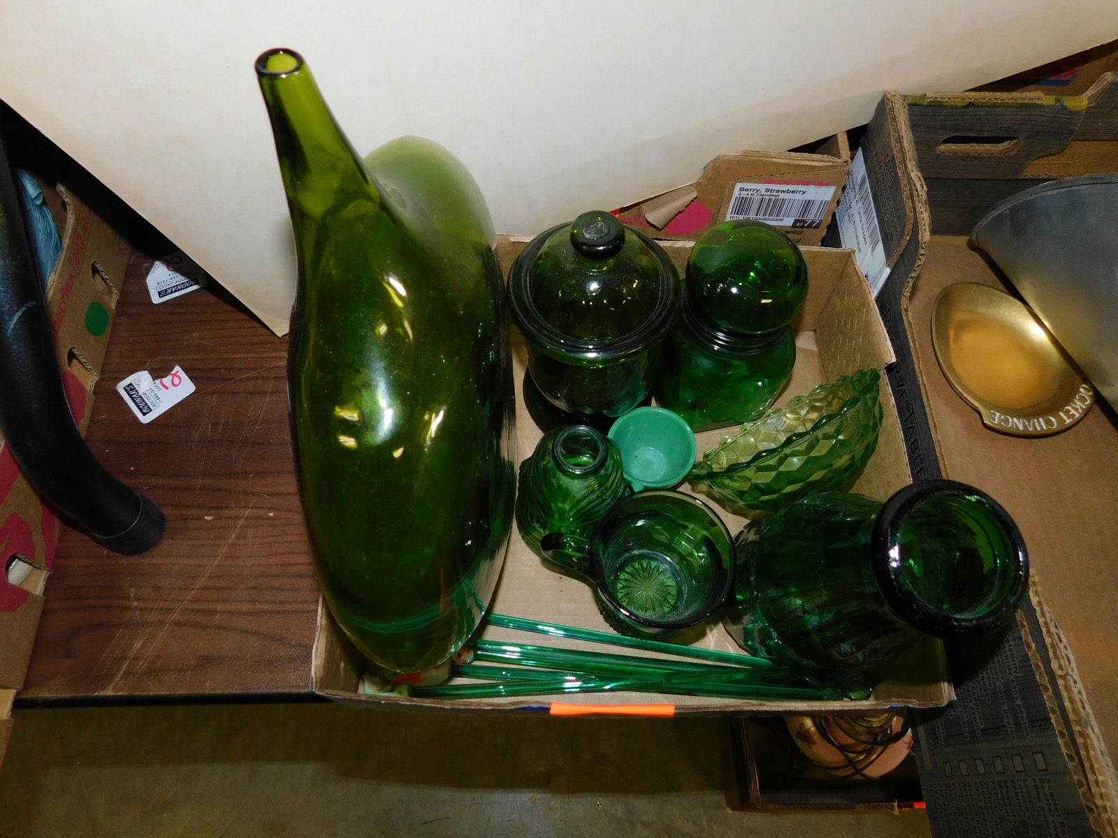 Box Lot of Green Glass: Box Lot of Green Glass. You are bidding at a live sale. Please read the terms and conditions. This sale will be broadcast live on sale day with full descriptions of each lot being sold, as well as vid