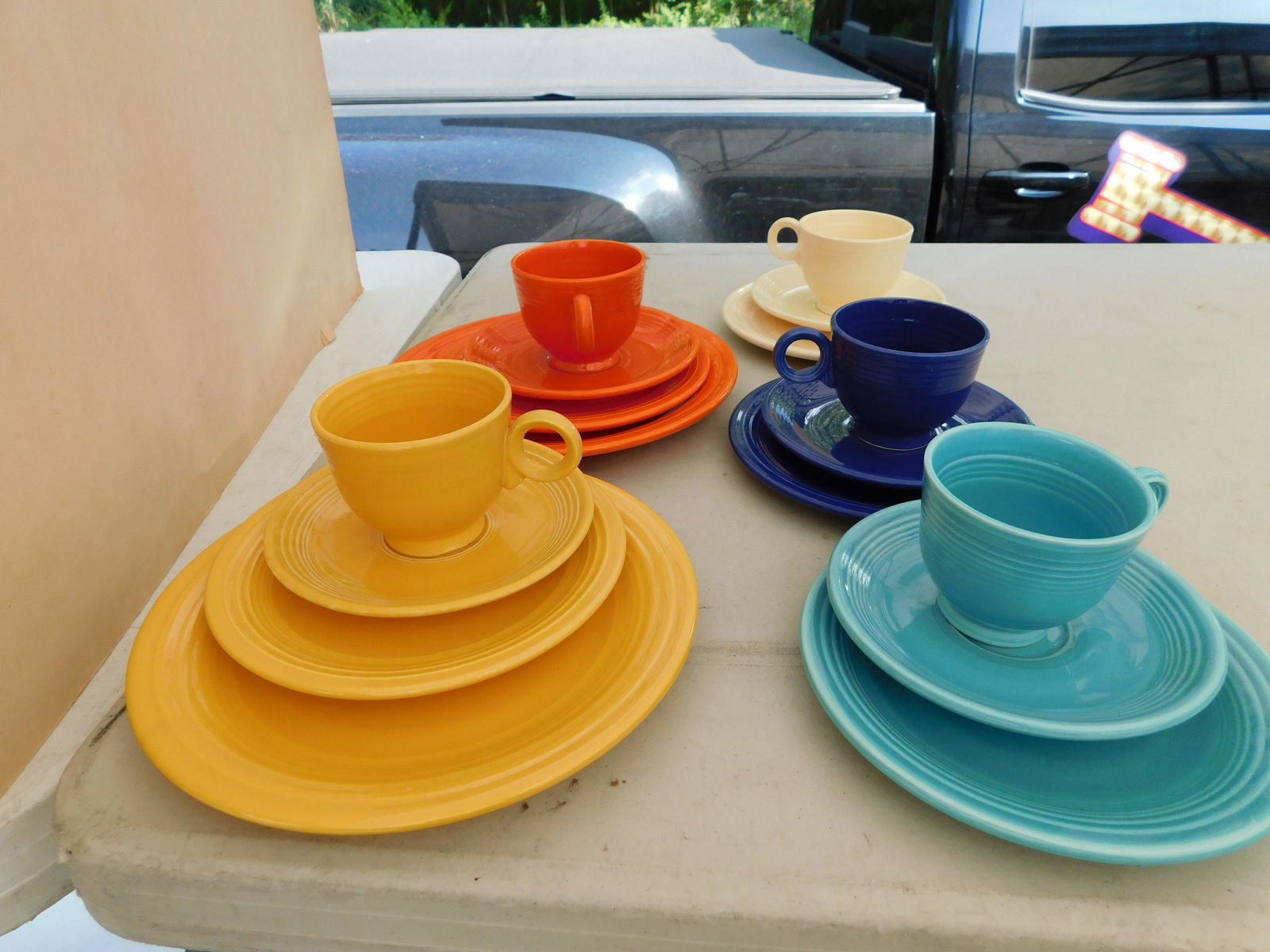 Lot of Fiestaware including Trios: Lot of Fiesta including 3 Sets of Trios and 2 Sets of 4 piece Place Settings. You are bidding at a live sale. Please read the terms and conditions. This sale will be broadcast live on sale day with fu