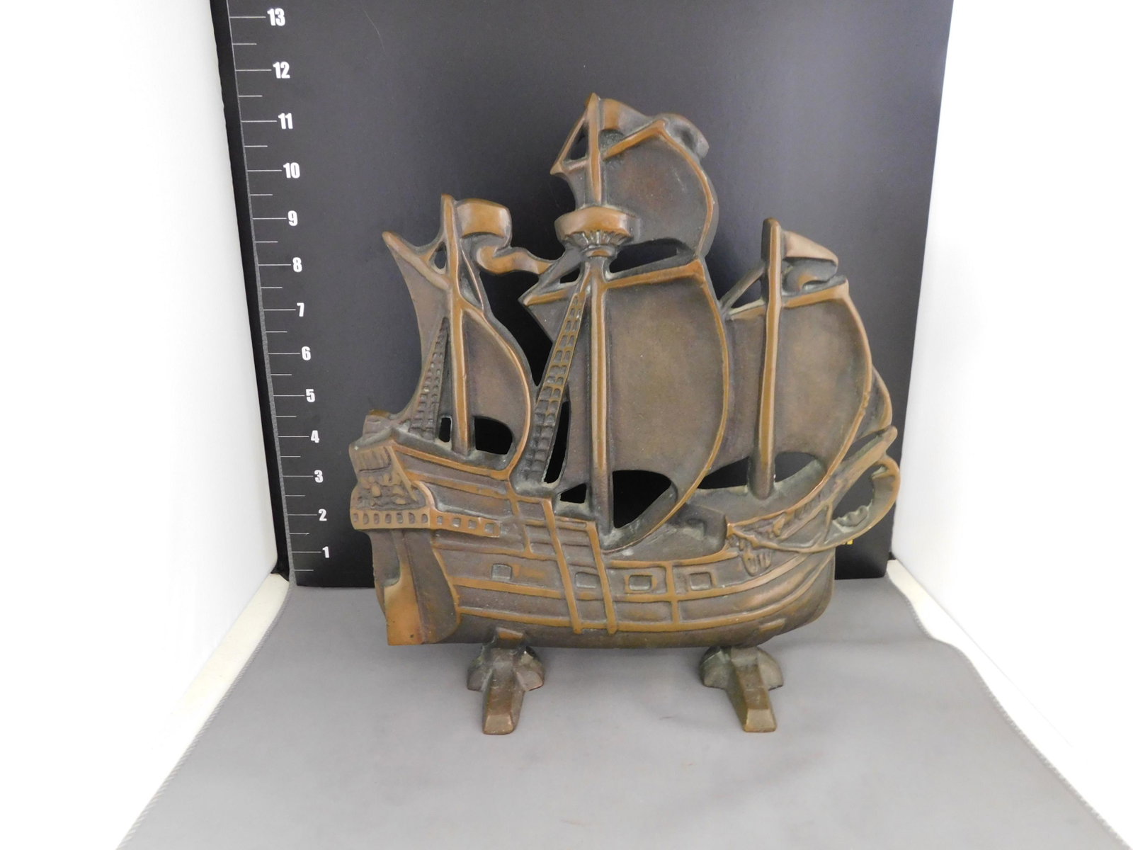 Cast Iron/Bronze Ship Doorstop: Cast Iron/Bronze Ship Doorstop. Vintage. Measures approx. 11.5" t x 10.5" w. You are bidding at a live sale, please read the terms and conditions. We are offering contact-less pick ups at our South Br