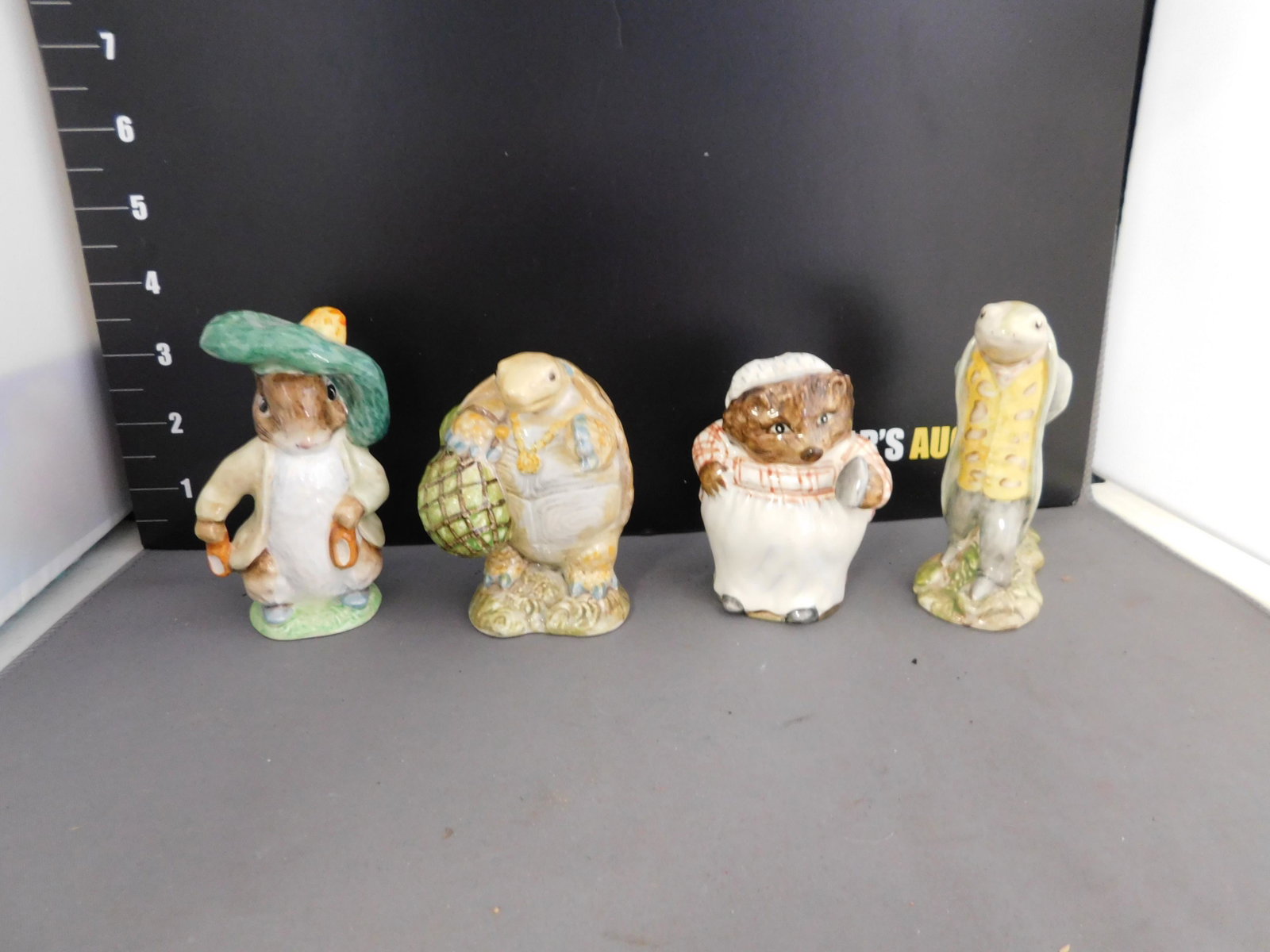 Lot of 4 Beatrix Potter Figurines: Lot of 4 Beatrix Potter Figurines including Mrs Tiggy Winkle, Benjamin Bunny, Mr Alderman Ptolemy, and Sir Issac Newton. You are bidding at a live sale, please read the terms and conditions. We are of