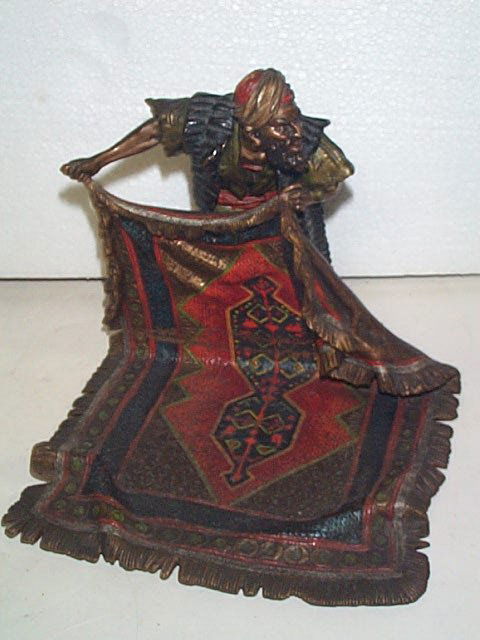 19th Century Very Fine Bronze of a man holding a r: 19th Century Very Fine Bronze of a man holding a rug Hand painted and signed: B, 5913, Goschufzt Also marked: BGRLL Measures 7" tall by &' long by 7" wide In beautiful condition Buyer to pay $15.00 if