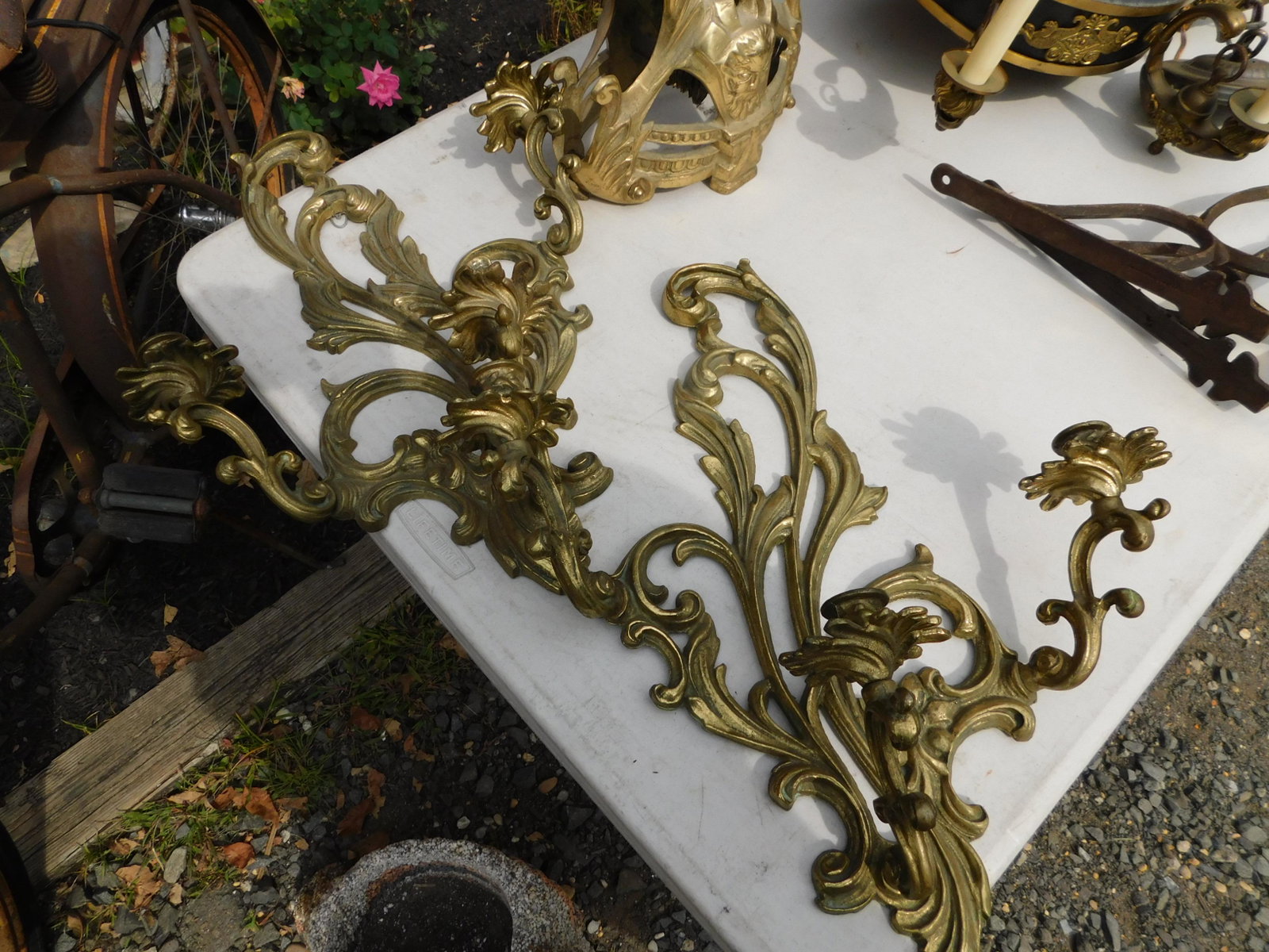 Pair of Brass Wall Sconces: Pair of Brass Wall Sconces. Measures 20" long x 16" w. You are bidding at a live sale. Please read the terms and conditions. This sale will be broadcast live on sale day with full descriptions of each