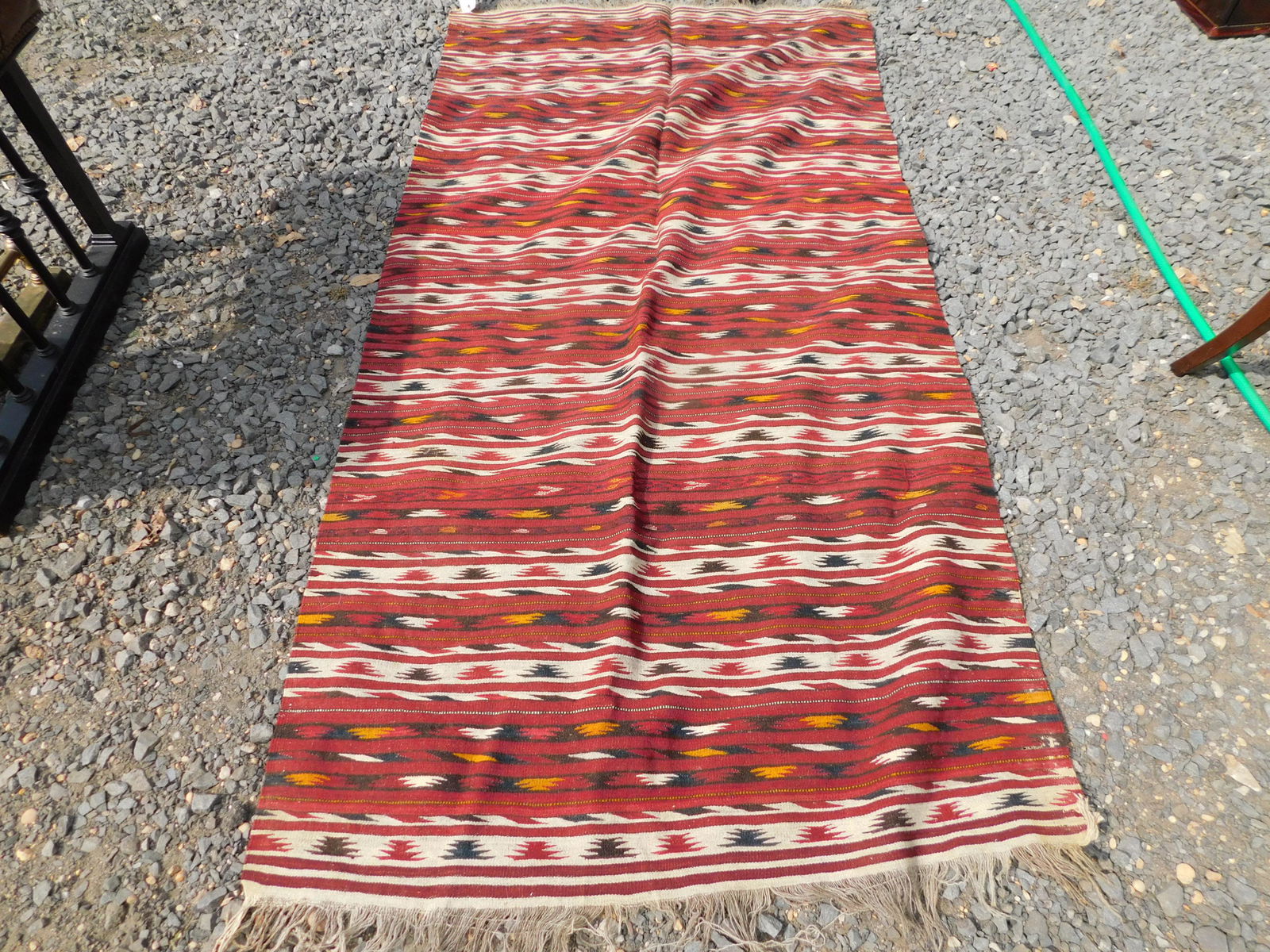 Handmade Rug: Handmade Rug. Measures 84" long x 43" wide. You are bidding at a live sale. Please read the terms and conditions. This sale will be broadcast live on sale day with full descriptions of each lot being