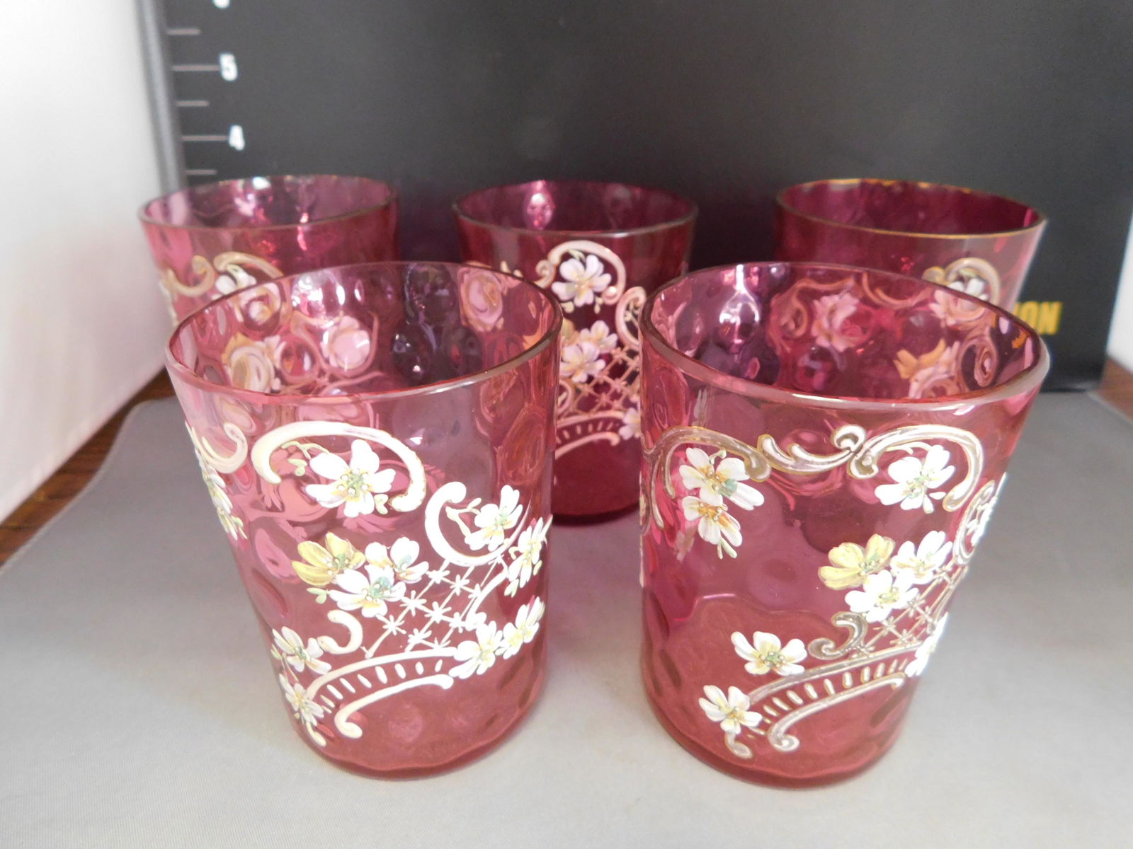 Victorian Cranberry Lemonade Glasses - Set of 5: Set of 5 Victorian Cranberry Thumbprint Lemonade Glasses. Enamel and Gold. Measures approx. 3.5" tall. You are bidding at a live sale, please read the terms and conditions. We are offering contact-les
