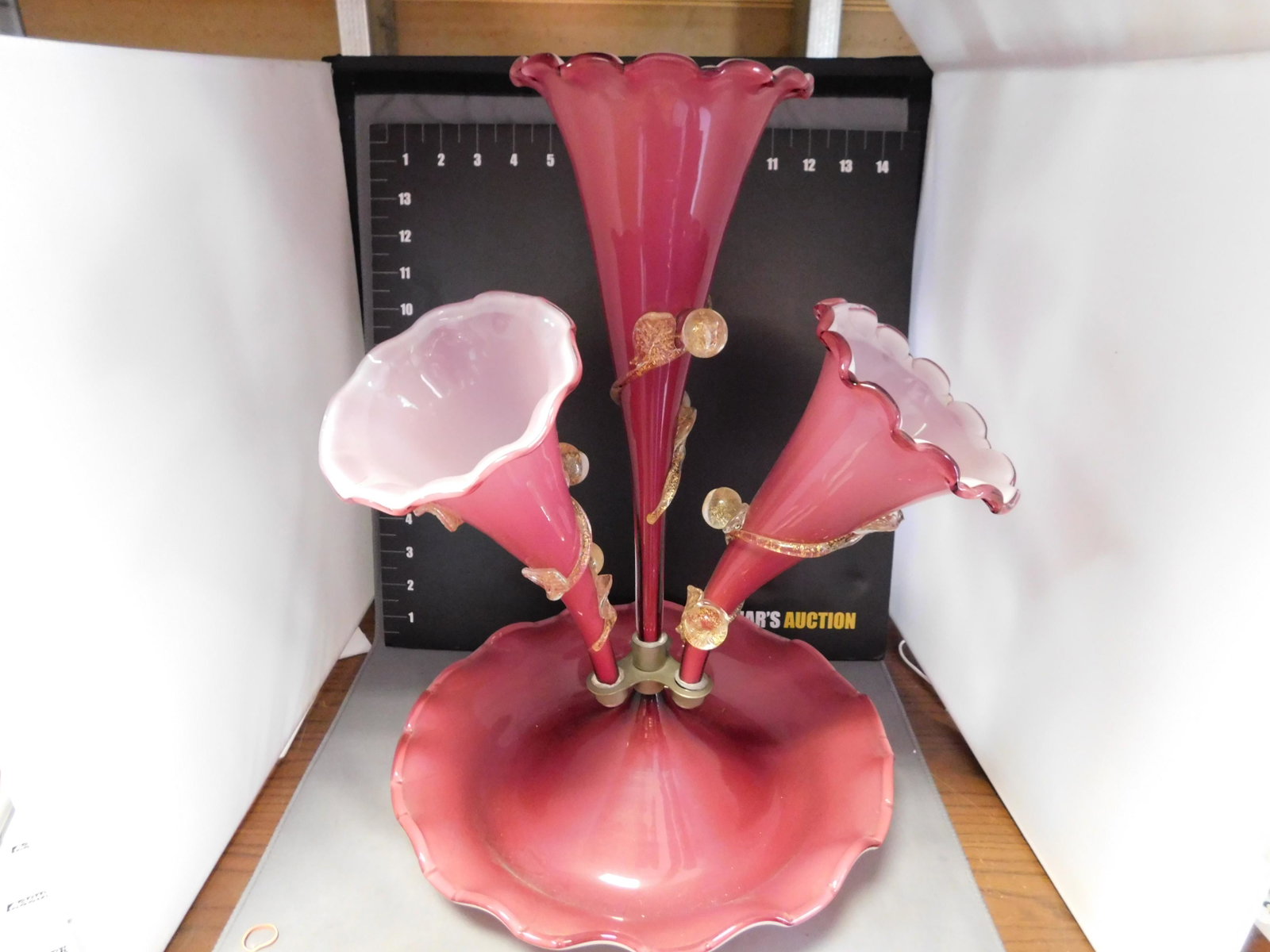 Victorian Style Epergne: Victorian Style Epergne. Cased Glass. Applied Design. One Smaller Horn Missing. Measures approx. 16" tall. You are bidding at a live sale, please read the terms and conditions. We are offering contact