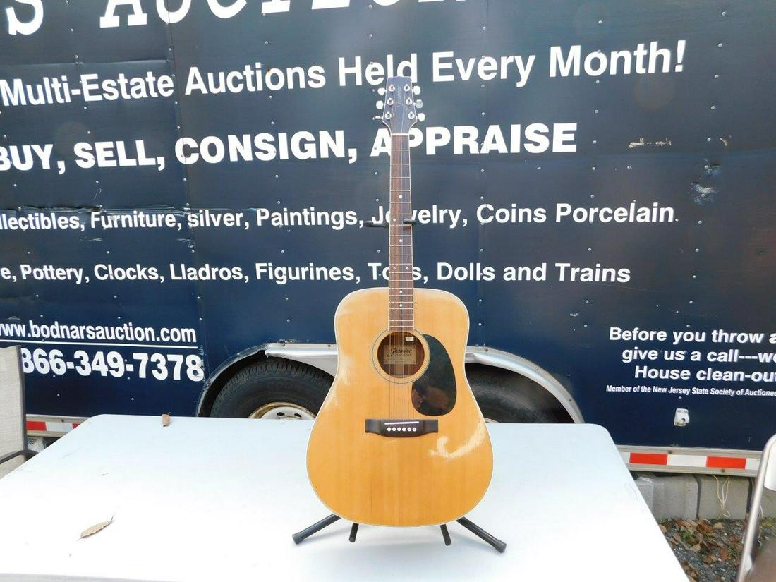 Jasmine by Takamine Acoustic Guitar: Jasmine by Takamine Acoustic Guitar S-60 Seriel 032499. Plays Great. All new strings and tuned. Stand not included. You are bidding at a live sale, please read the terms and conditions. We are offerin