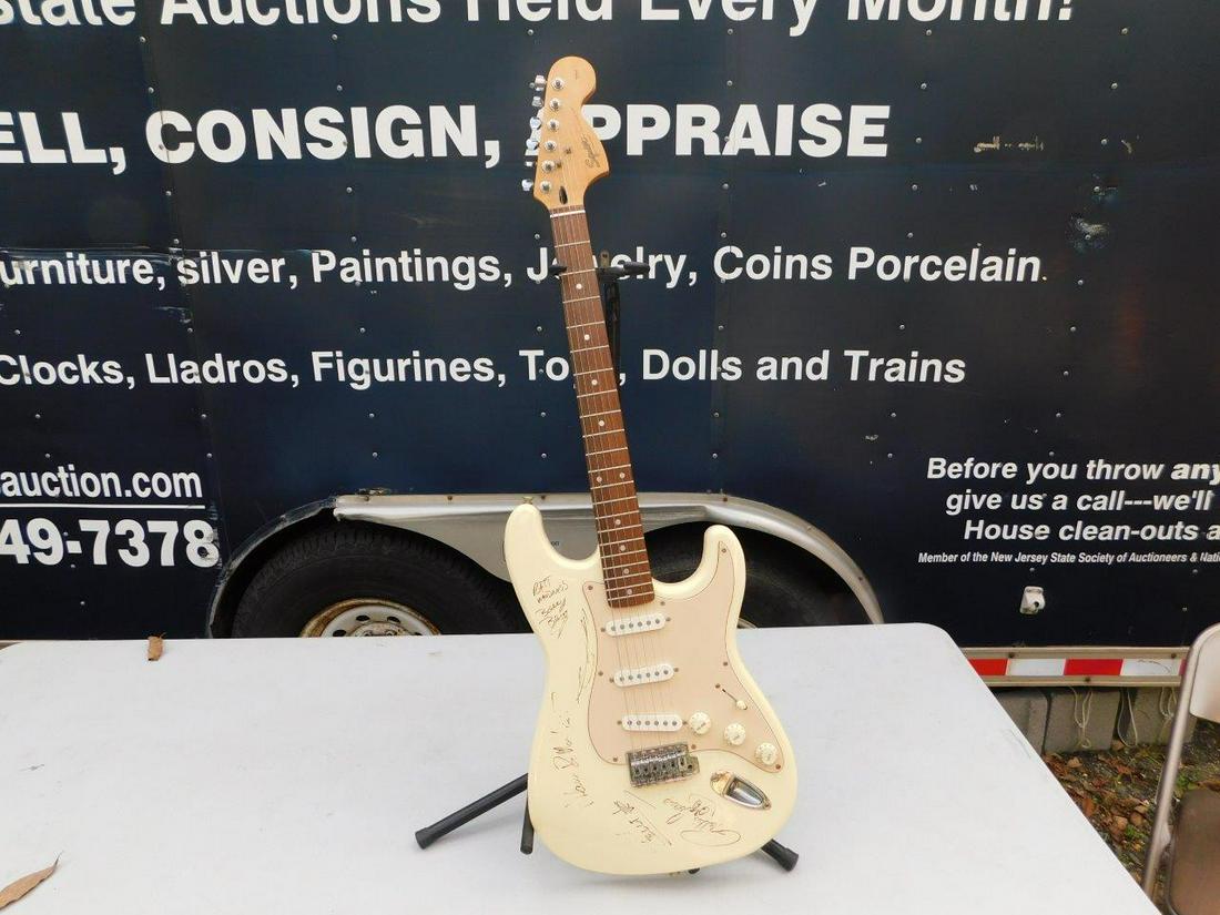 Squier Stratocaster by Fender: Squier Stratocaster by Fender Electric Guitar Seriel CY98116436. Autographed by the entire group RATT. Signatures have not been verified but appear to be correct. Stand not included. Plays Great - New
