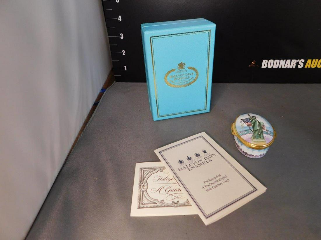 Enamel Trinket Box Tiffany & Co. Satue of Liberty: Halcyon Days Enamel Statue of Liberty Trinket Box Designed by Tiffany and Co. with Original Box and Paperwork. Measures 1" t x 2" w. You are bidding at a live sale, please read the terms and condition