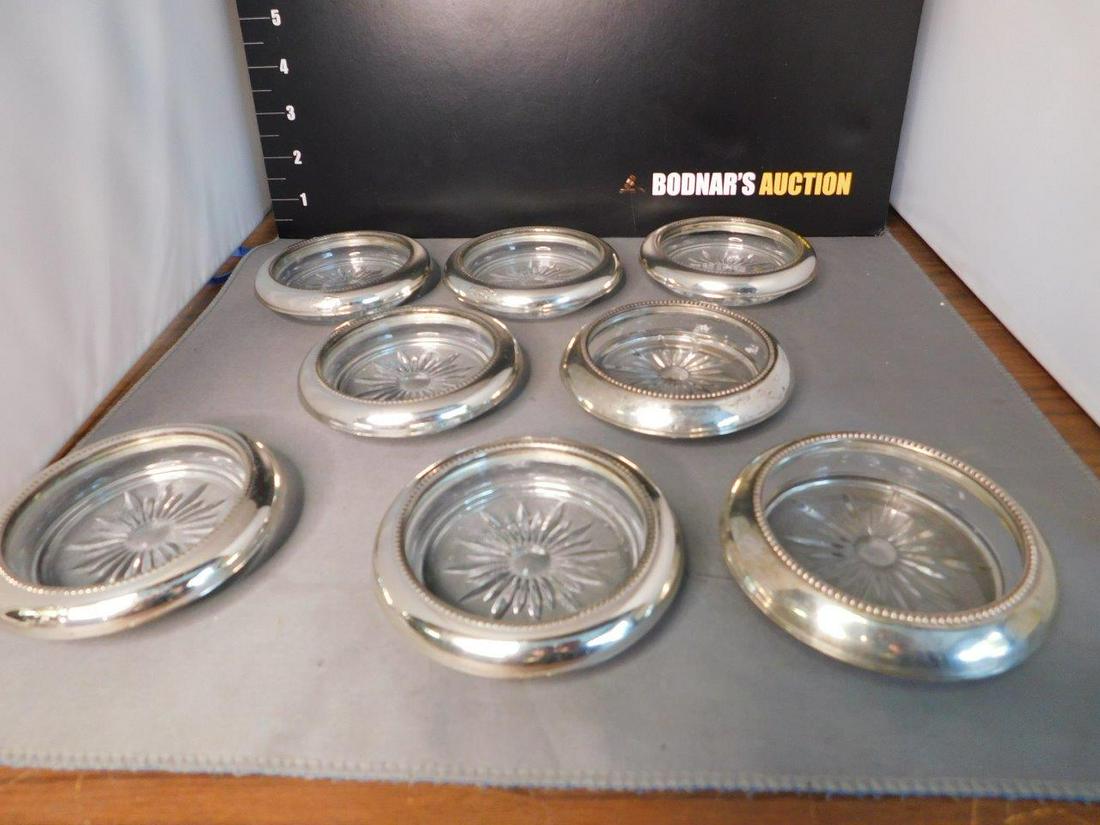 Lot of 8 Sterling Silver and Crystal Coasters: Set of 8 Sterling Silver Rimmed and Crystal Coasters. You are bidding at a live sale, please read the terms and conditions. We are offering contact-less pick ups at our South Brunswick location by APP