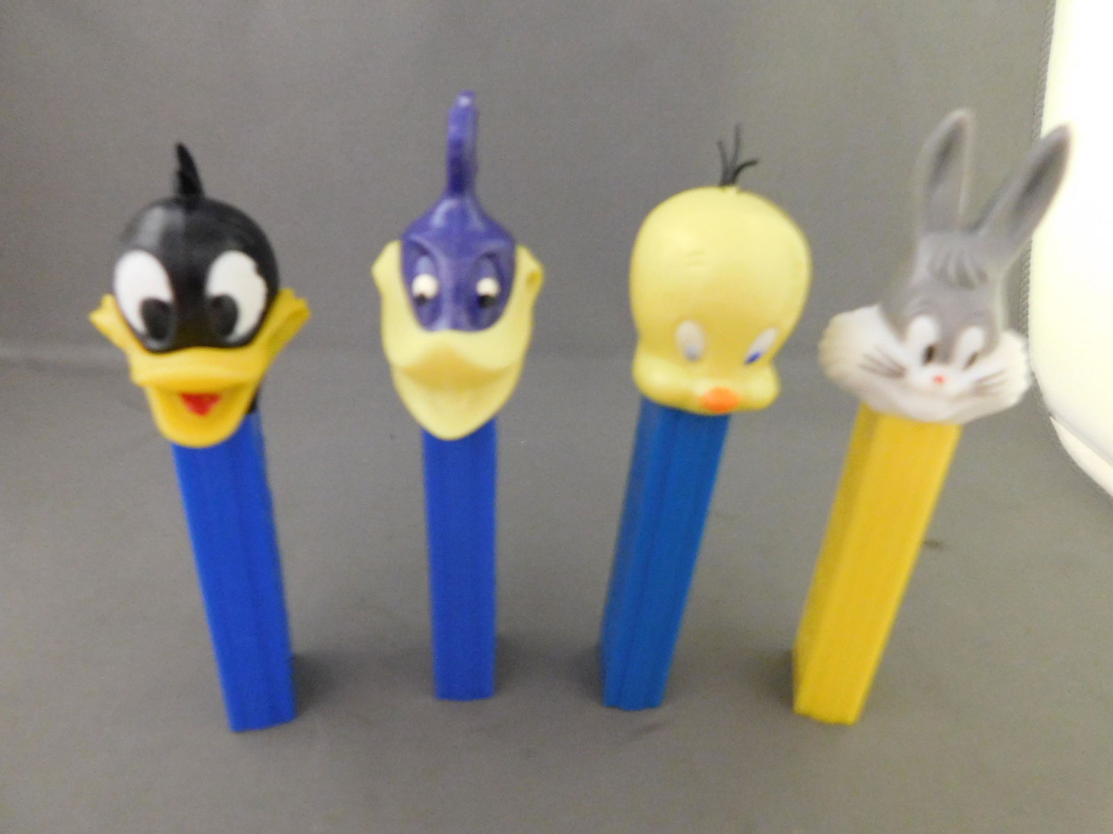 Looney Tunes Vintage Pez Lot of 4: Looney Tunes Vintage Pez Lot of 4. They all have no feet. Included in this lot are Tweety and Bugs Bunny made in Hong Kong, Road Runner Made in Austria, and Daffy Duck US Patent. You are bidding at a