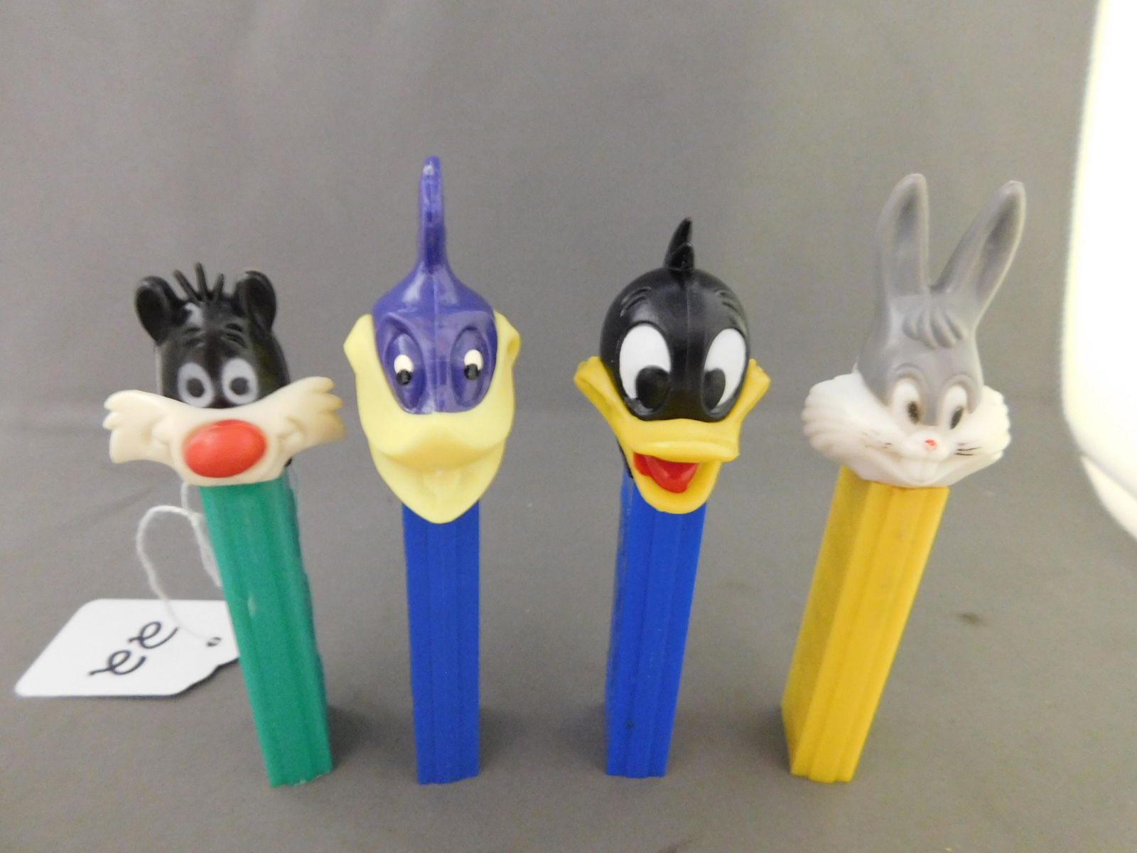 Looney Tunes Vintage Pez Lot of 4: Looney Tunes Vintage Pez Lot of 4. They all have no feet. Included in this lot are Bugs Bunny and Sylvester made in Hong Kong, Road Runner made in Austria, and Daffy Duck made in the USA. You are bidd