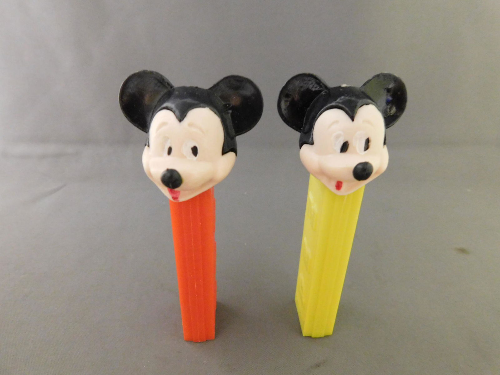 Disney Vintage Mickey Mouse Pez Lot: Disney Vintage Mickey Mouse Pez Lot of 2. They both have no feet. One has a yellow body and the other has a red body. Both are made in Hong Kong. You are bidding at a live sale, please read the terms