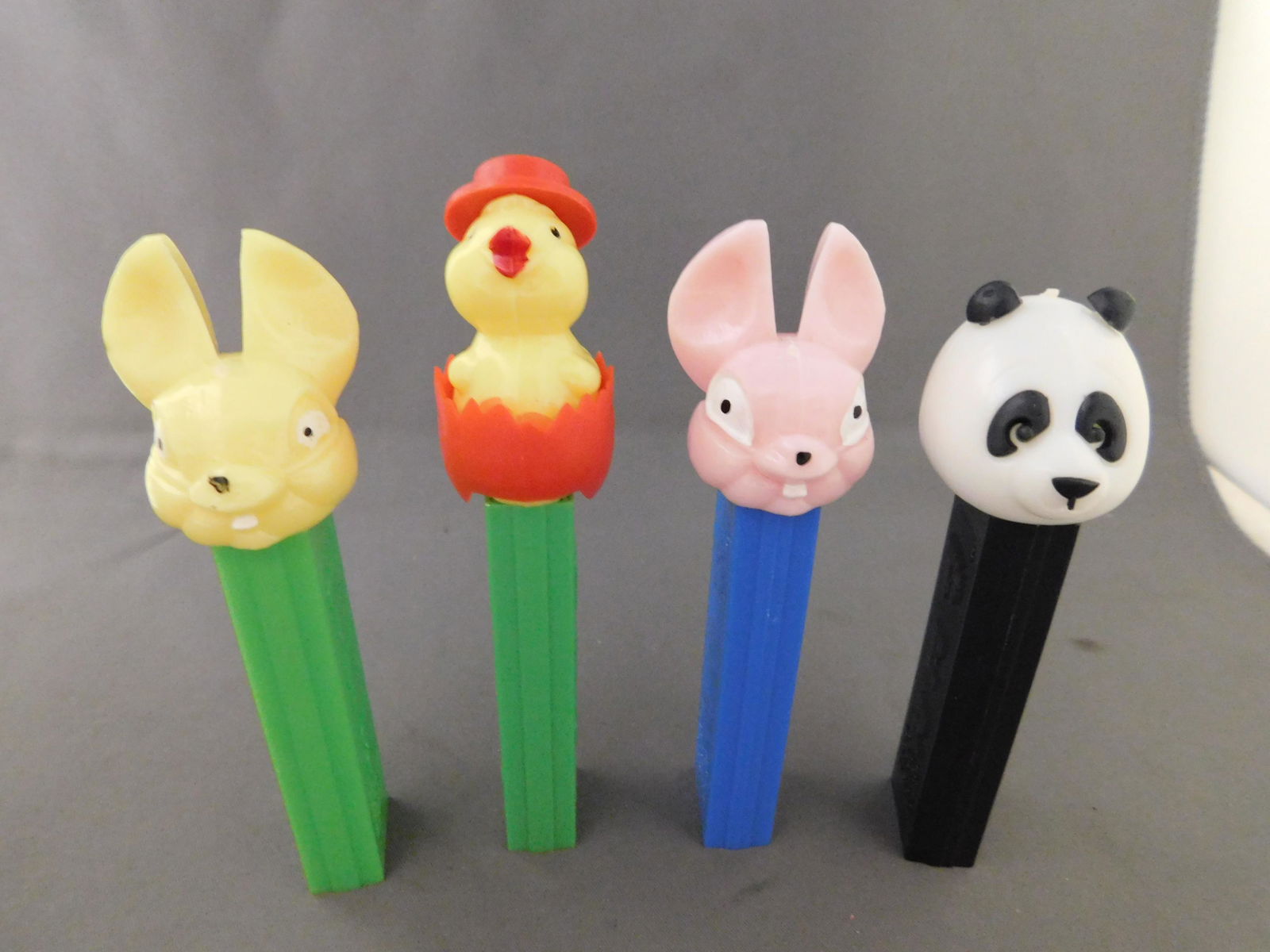 Vintage Easter Pez Lot of 4: Vintage Easter Pez Lot of 4. They all have no feet. Included in this lot are a Panda, 2 Easter Bunny's one with a yellow head and one with a pink head, and a chick hatching out of an egg all made in A