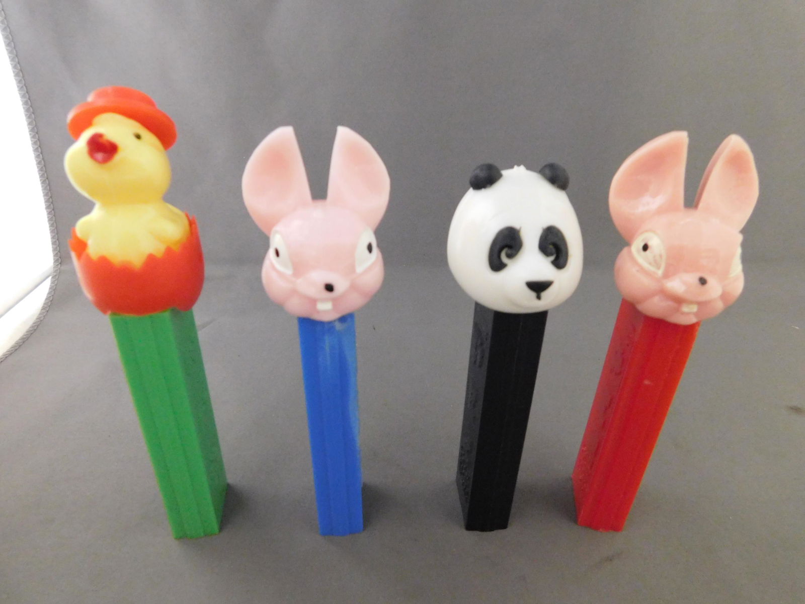 Vintage Easter Pez Lot of 4: Vintage Easter Pez Lot of 4. They all have no feet. Included in this lot are a Panda, a Chick Hatching, and an Easter Bunny all made in Austria, and an Easter Bunny with a red body made in Yugoslavia.
