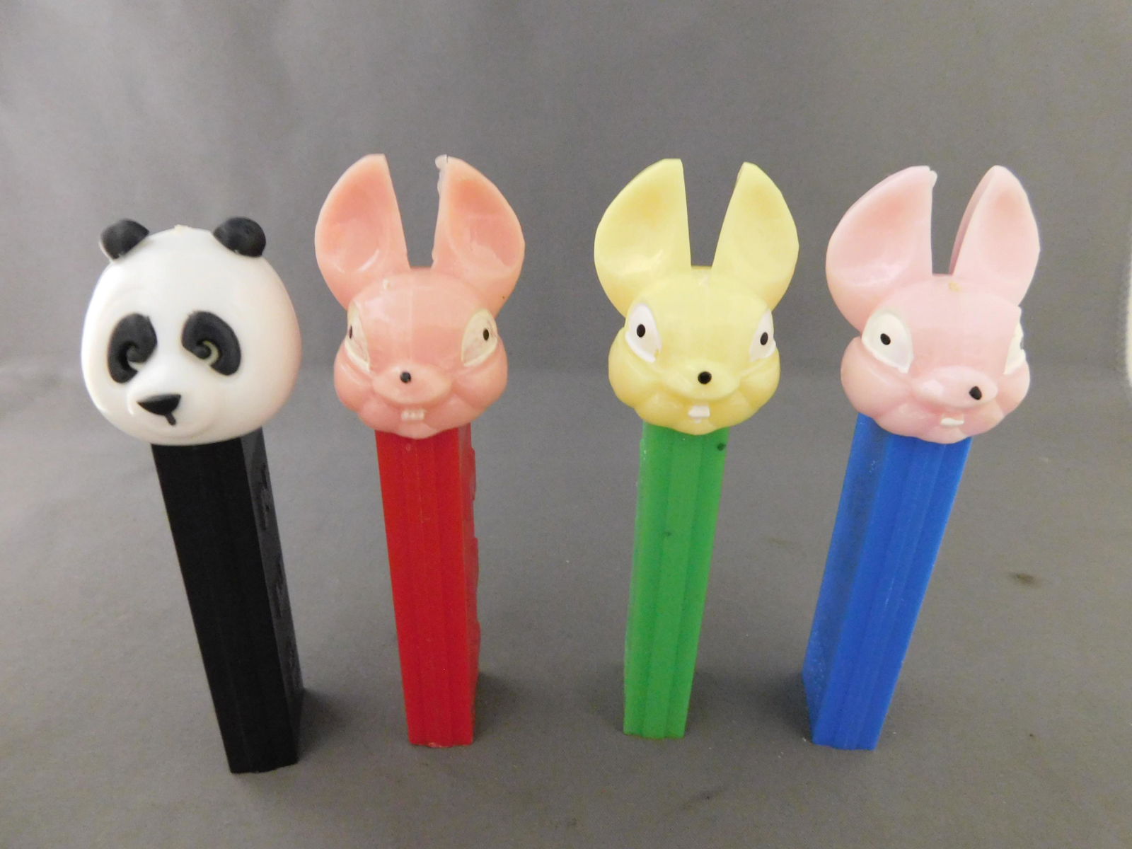 Vintage Easter Pez Lot of 4: Vintage Easter Pez Lot of 4. They all have no feet. Included in this lot are a Panda and 2 Easter Bunnies made in Austria and an Easter Bunny with a red body made in Yugoslavia. You are bidding at a l