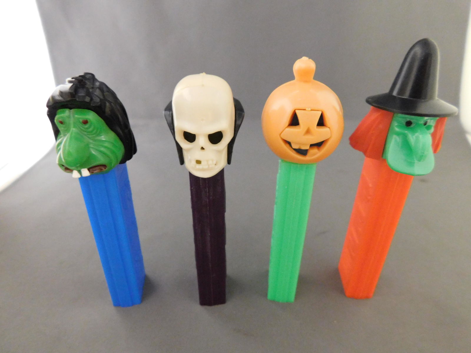 Vintage Halloween Lot of 4 including Ugly Man: Vintage Halloween Pez Lot of 4. They all have no feet. Included in this lot are Ugly Man, Witch, Skull, and Pumpkin. They are all made in Austria. You are bidding at a live sale, please read the terms